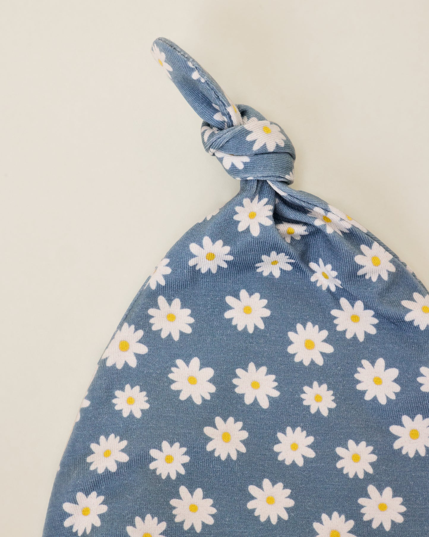 Close up of Bamboo Knotted Baby Gown & Hat in Blue Daisies print, showing a hat detail