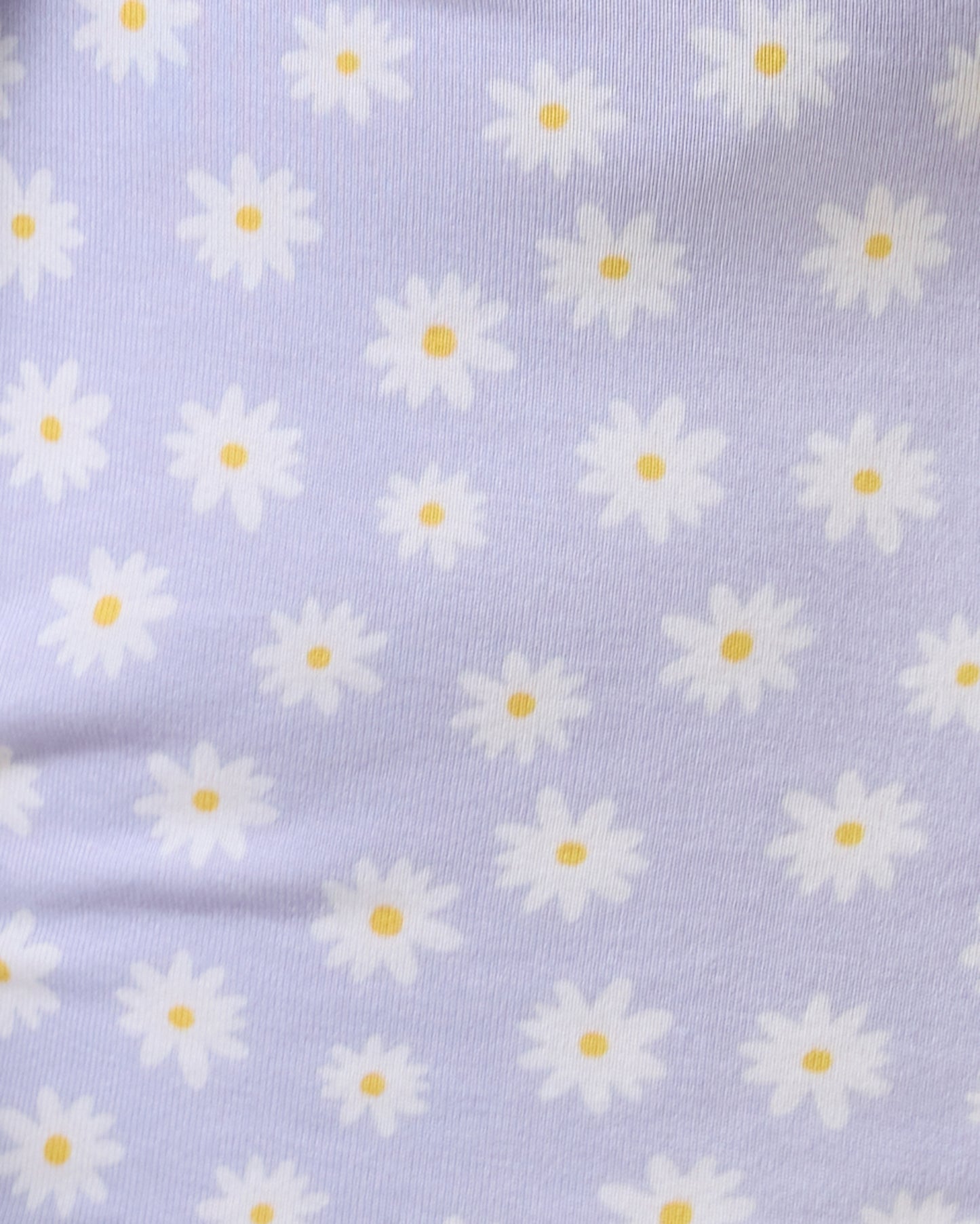 Close up of Baby wearing the Bamboo Baby Pajama in Purple Daisies print