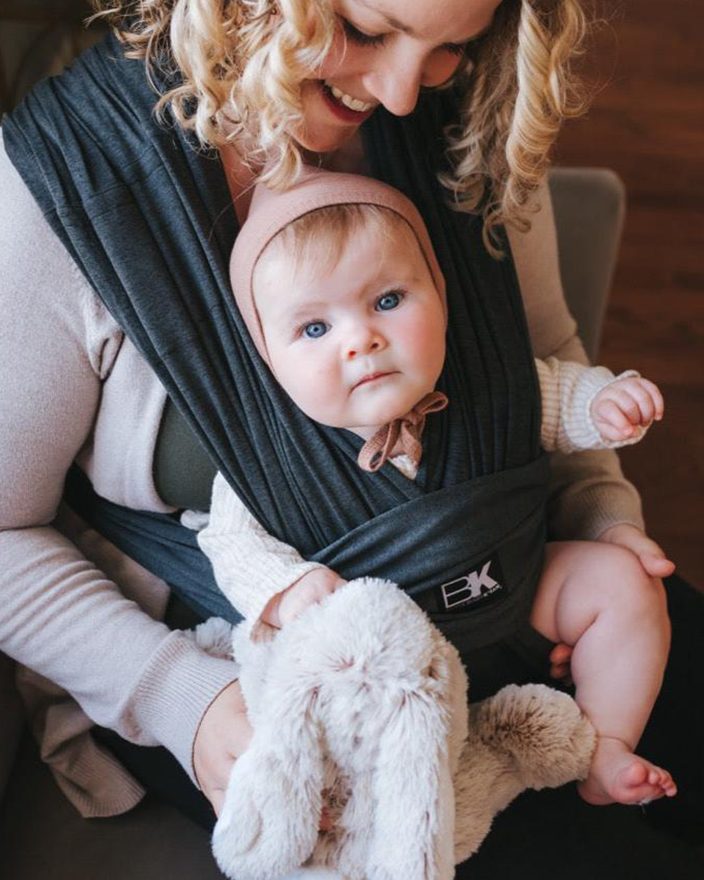 Close up of baby on  model wearing the Baby K'tan - Active Yoga Baby Carrier in Heather Black