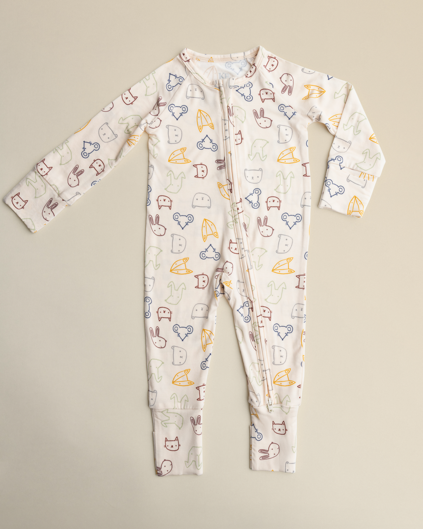 Bamboo Baby Pajamas in Critter Crew on a beige background