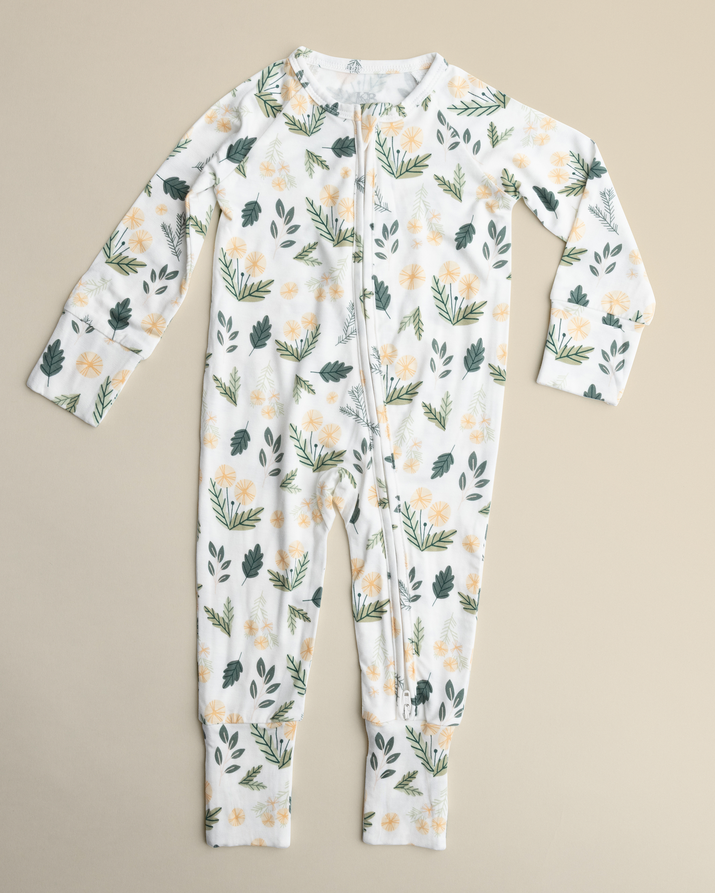 Bamboo Baby Pajamas in Honey Dandelion on a beige background