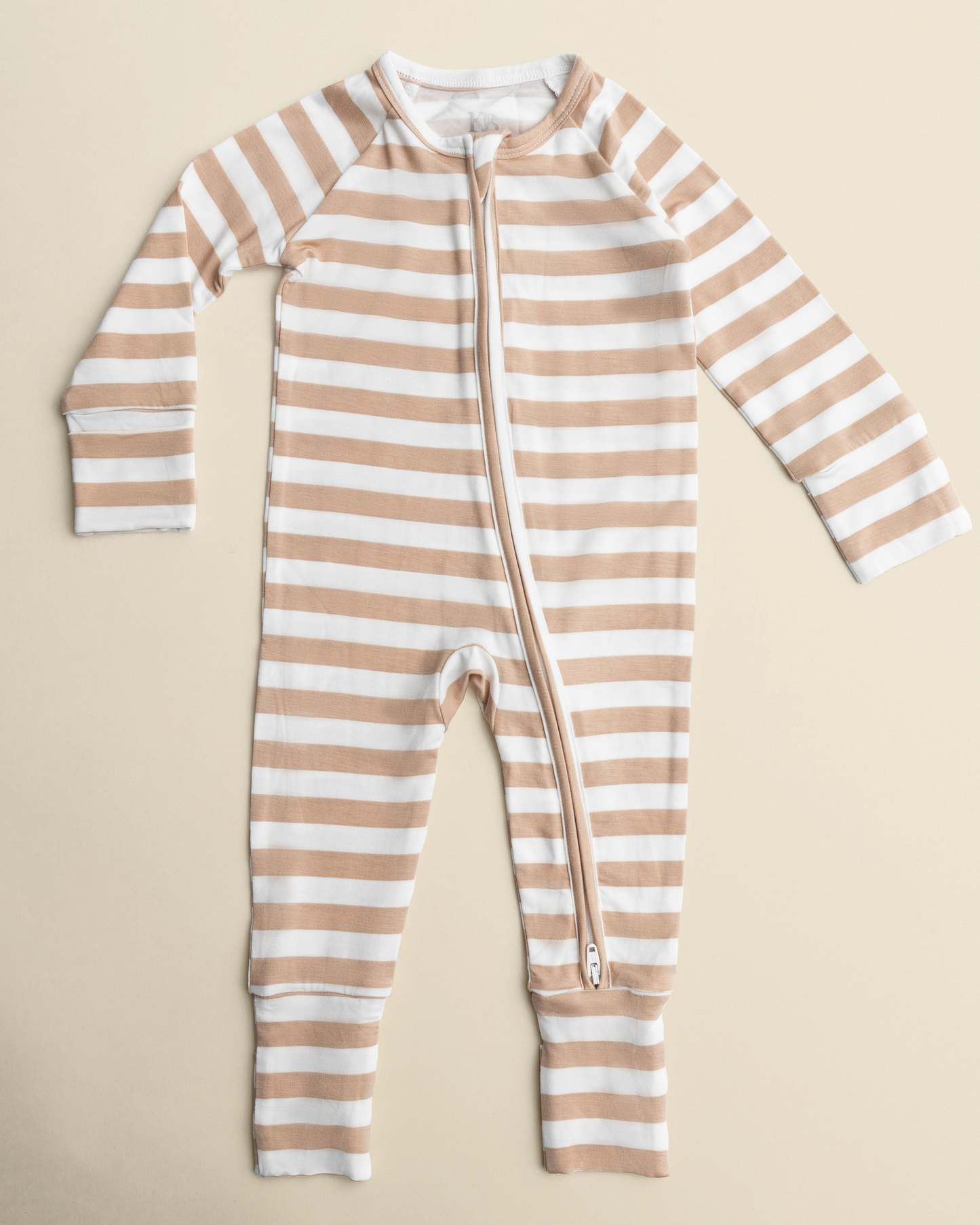 Bamboo Baby Pajamas in Fawn Stripe with a zipper on a beige background