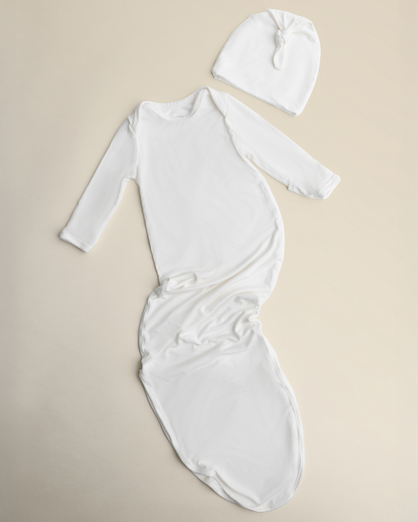 Bamboo Knotted Baby Gown in Pearl on a beige background
