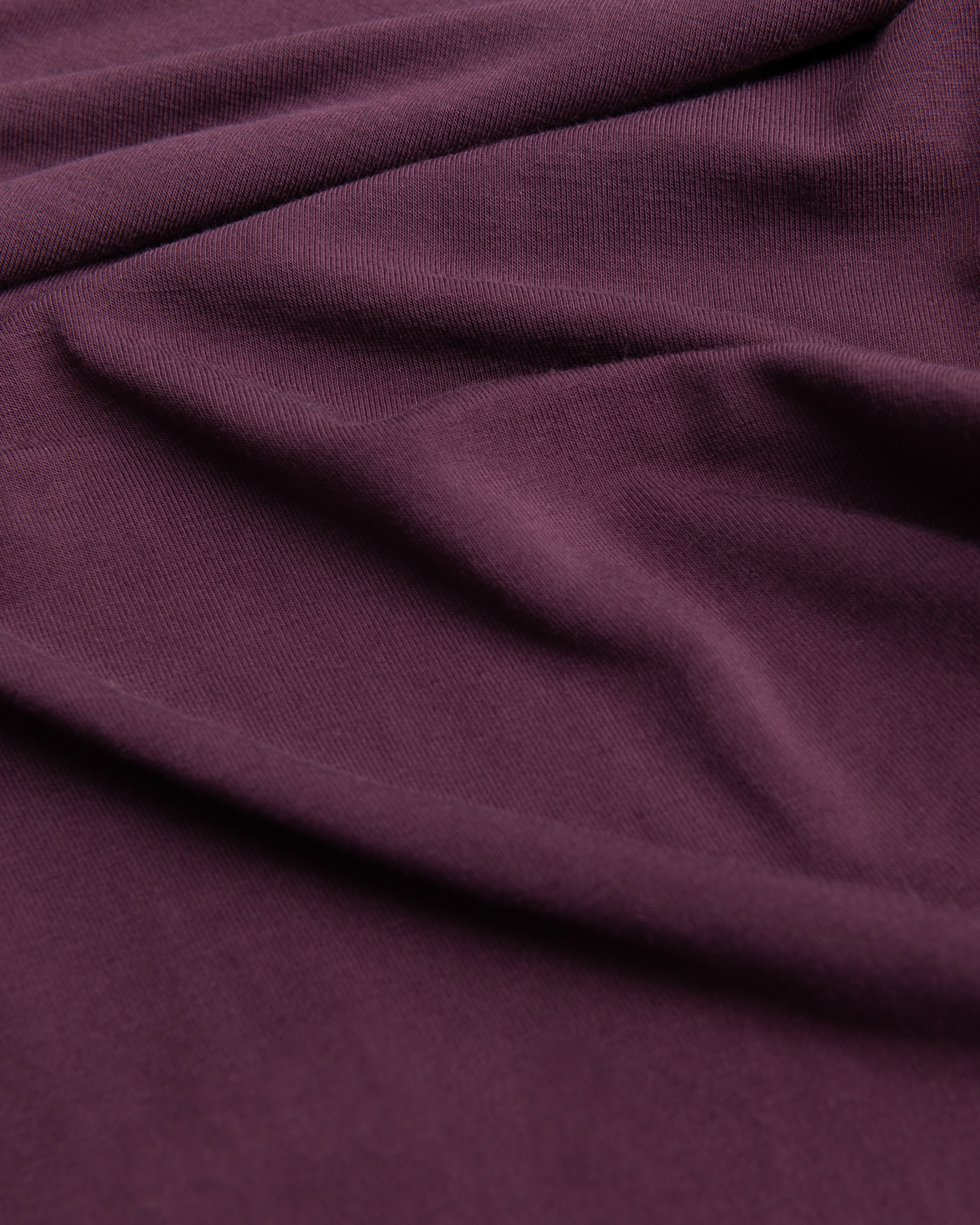 Close-up of wearing Bamboo Baby Pajamas in Burgundy Plum with folds