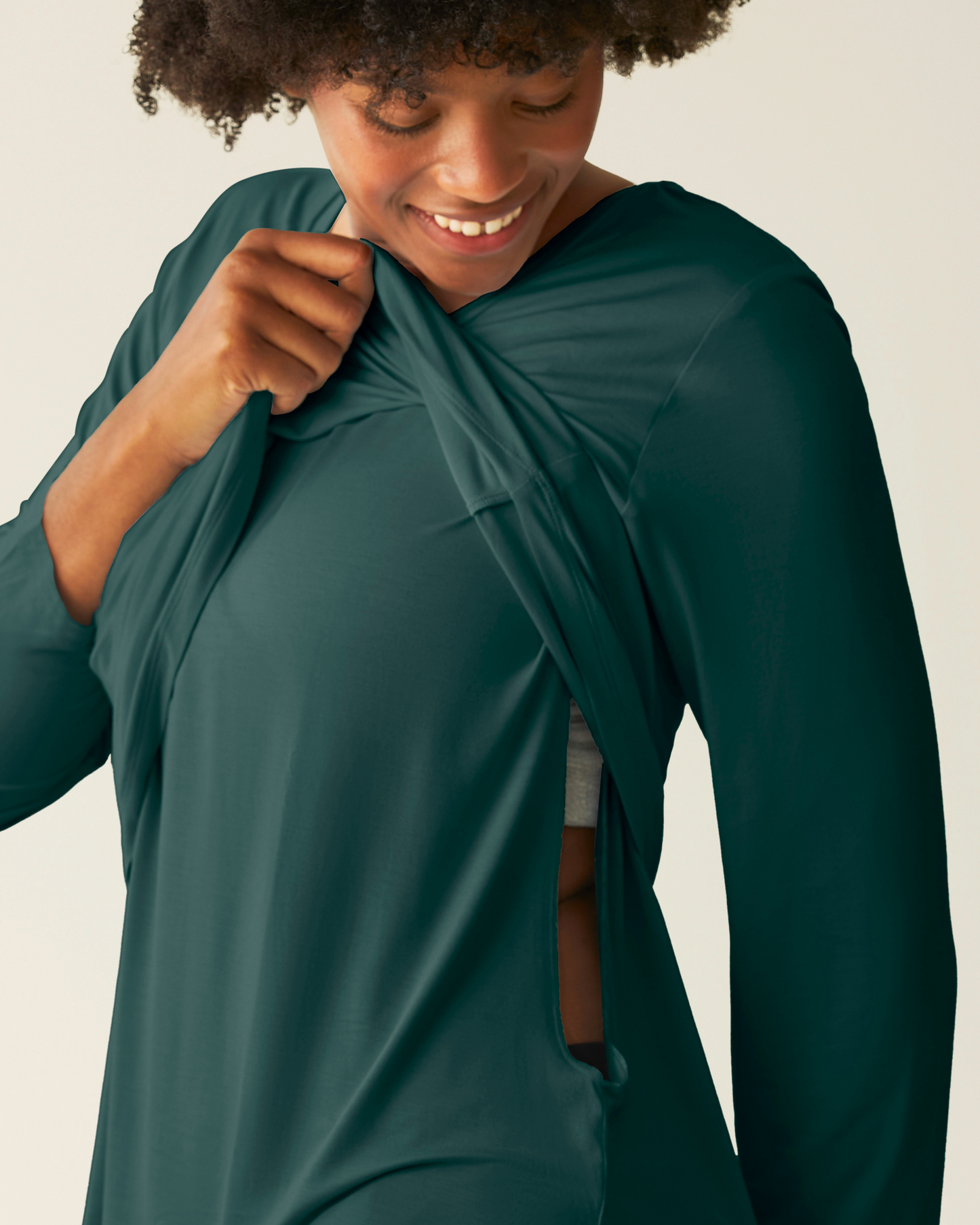 Woman wearing the Bamboo Maternity & Nursing Long Sleeve T-shirt in Evergreen, showing hidden nursing access
