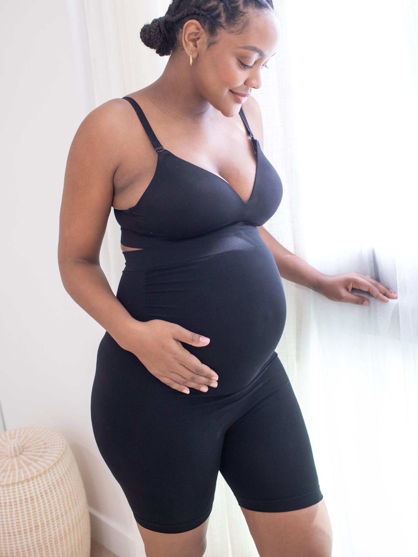 Side view of a pregnant model wearing the Seamless Bamboo Maternity Thigh Savers in Black@model_info:Roxanne is wearing a Large.