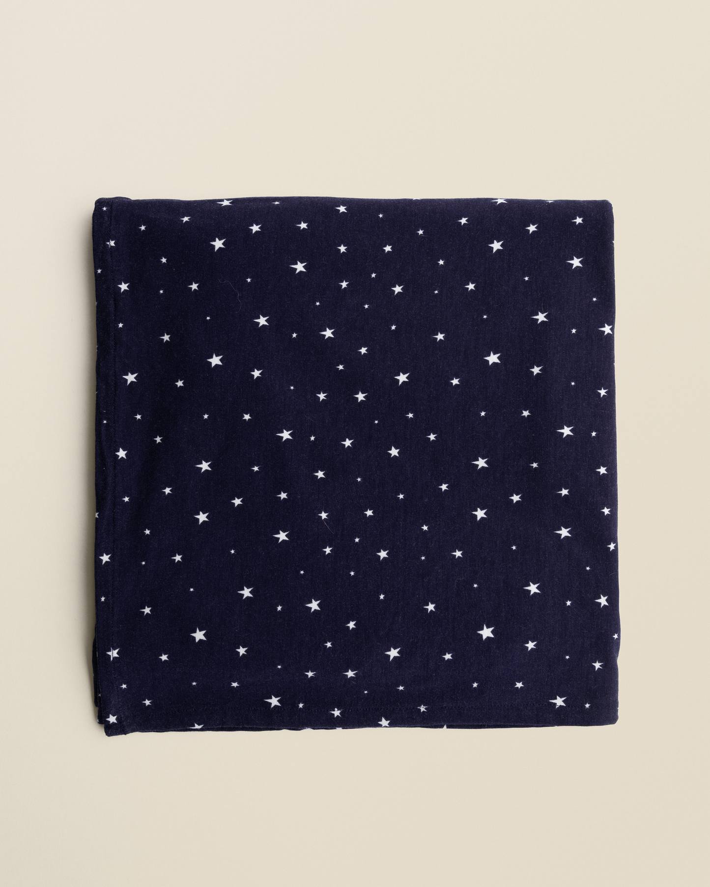 Bamboo Swaddle Blanket in Navy Stars on a beige background