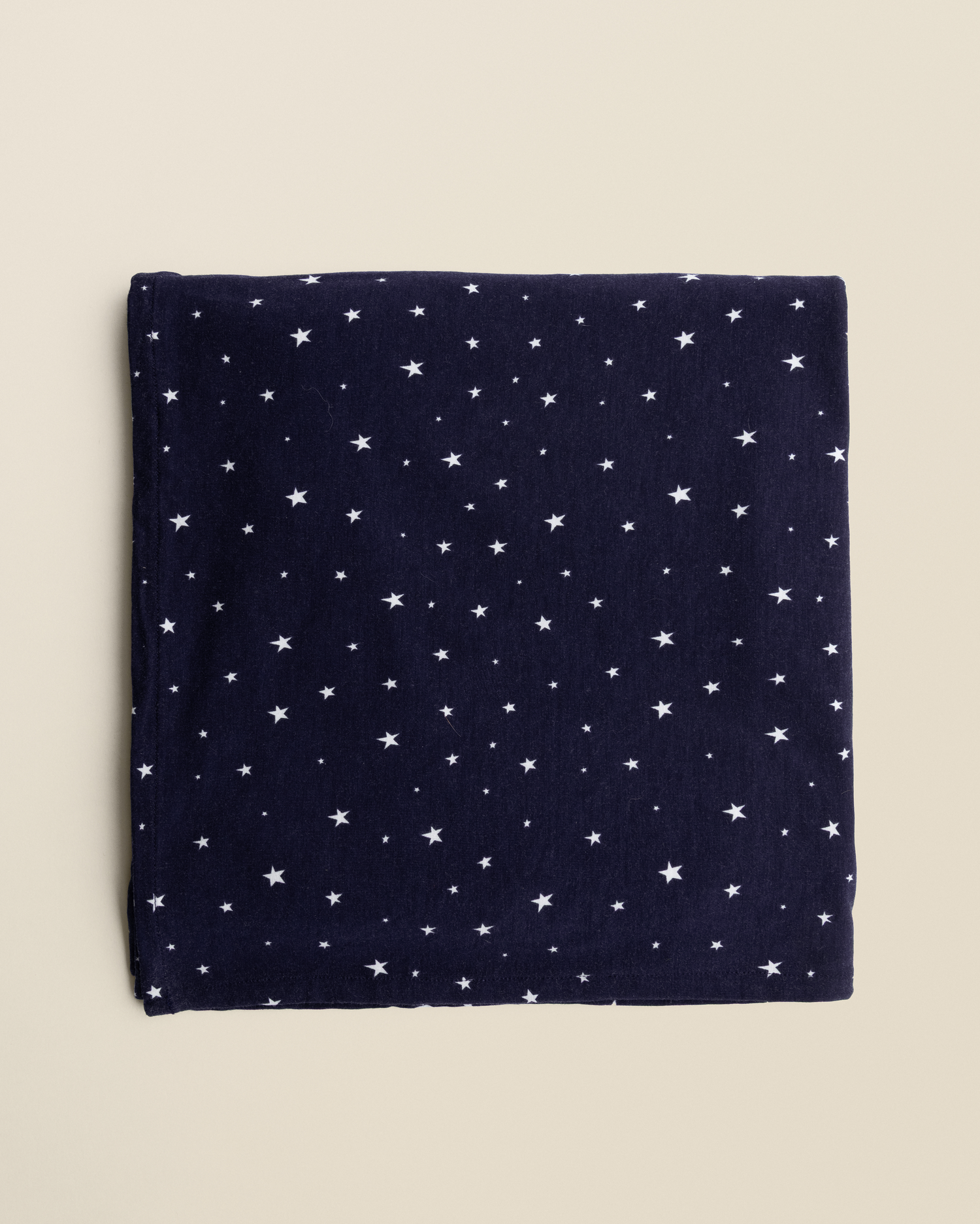 Bamboo Swaddle Blanket in Navy Stars on a beige background