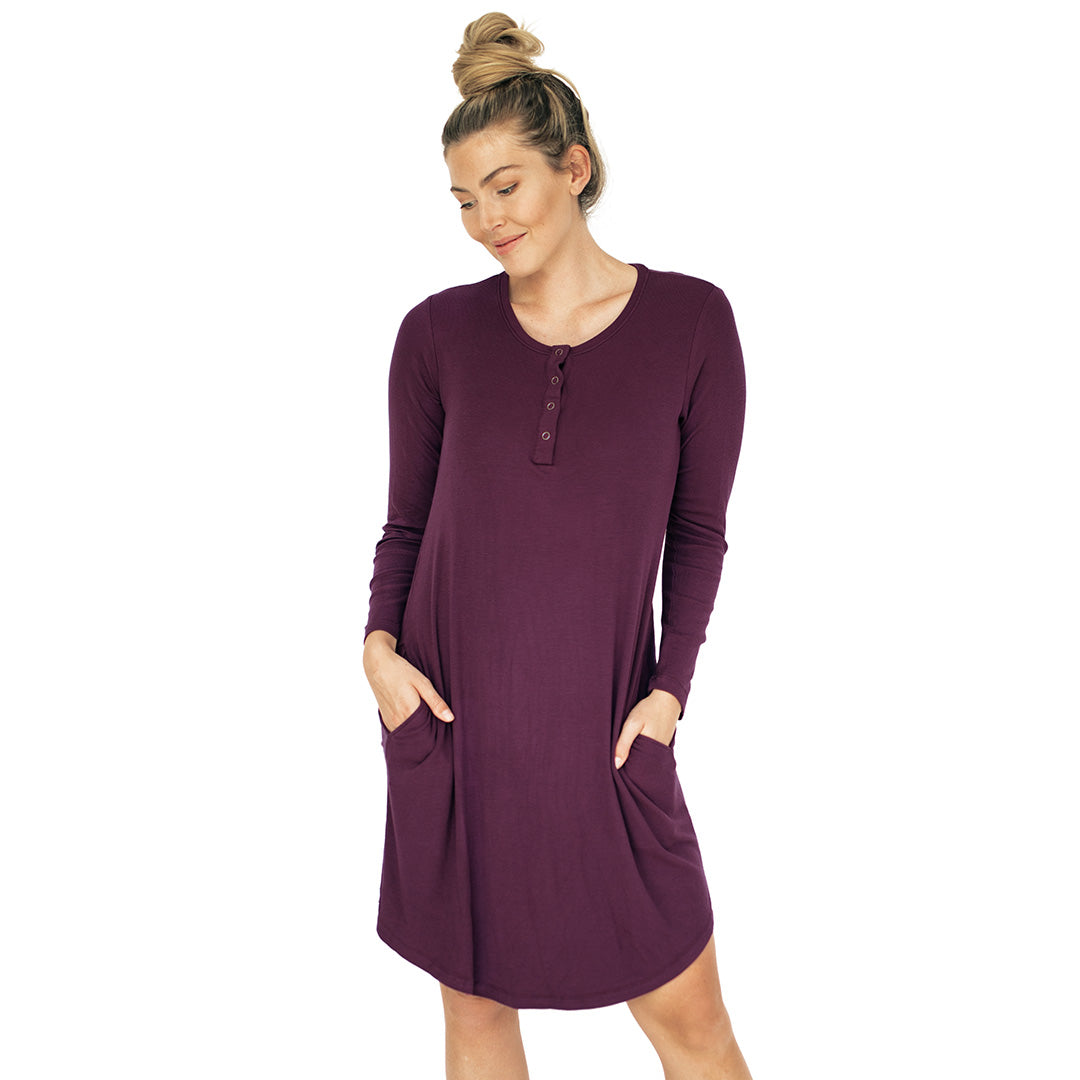 Model wearing the Betsy Ribbed Bamboo Maternity & Nursing Nightgown in Burgundy Plum with her hands in the pocket. @model_info:Karin is wearing a Medium.