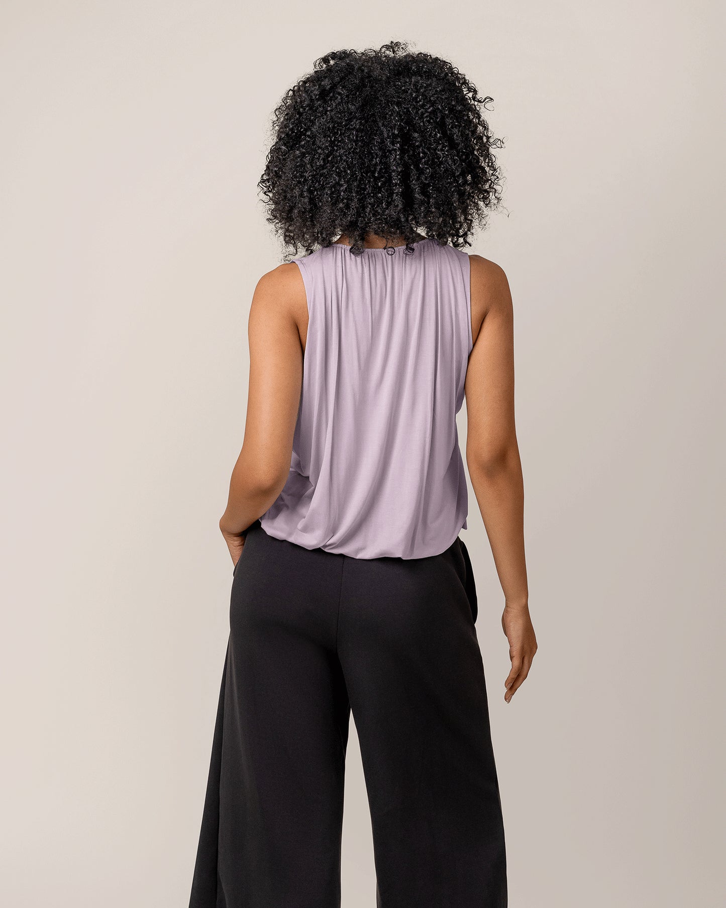 Back view of model wearing the Piper Bubble Hem Nursing Tank in Lavender Mist