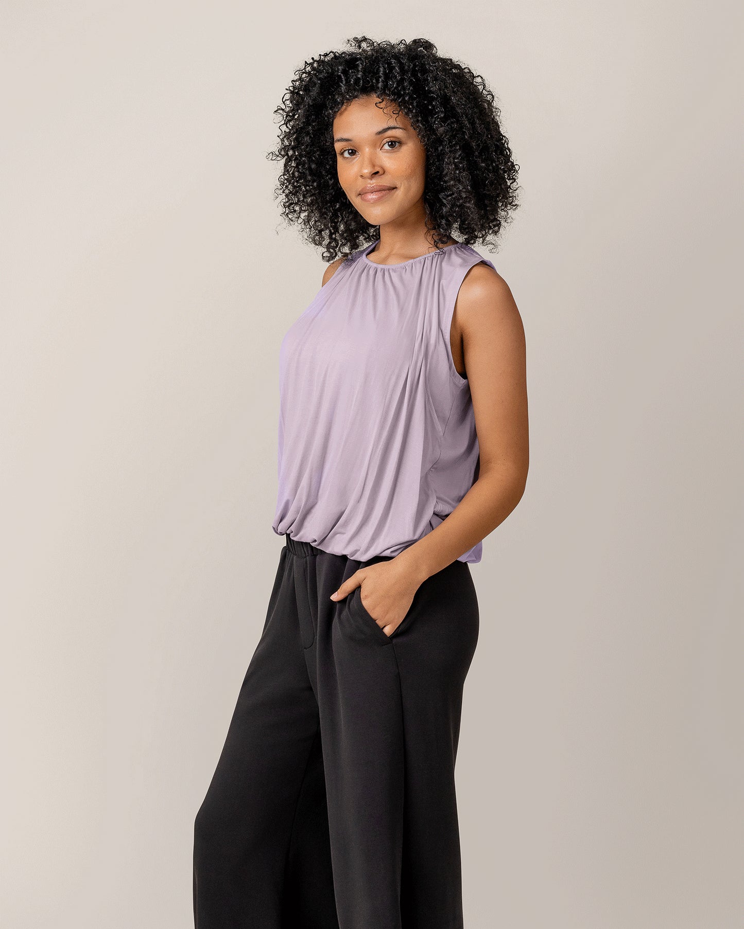 Side view of model wearing the Piper Bubble Hem Nursing Tank in Lavender Mist