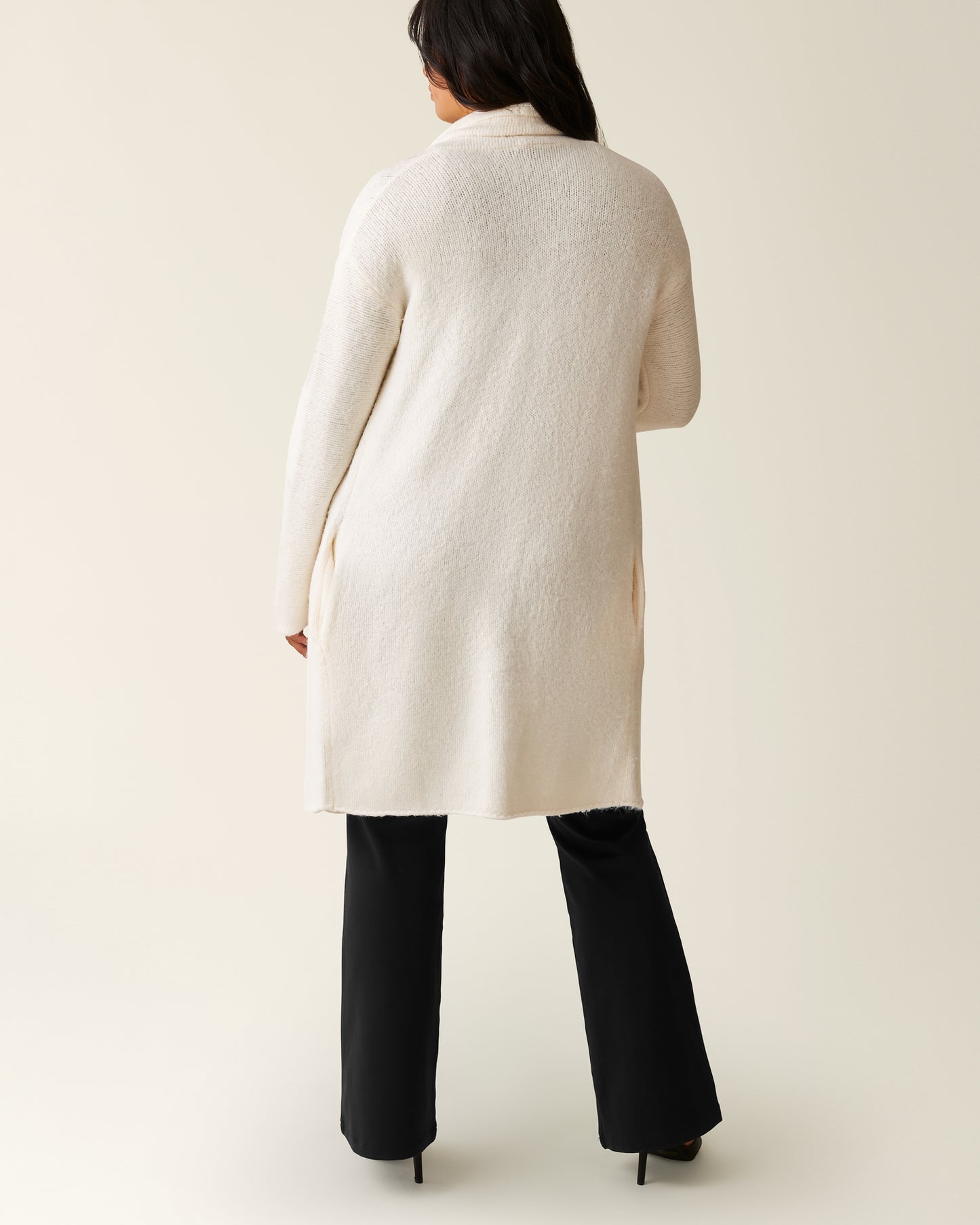 Back of woman wearing the Chloe Cardigan Sweater in Ecru