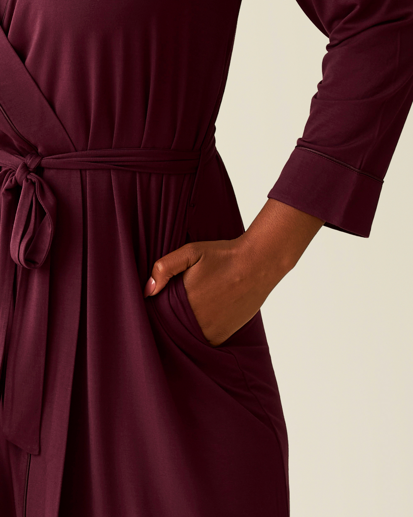 Cropped in image of woman wearing the Clea Bamboo Robe in Deep Burgundy, with hand in pocket