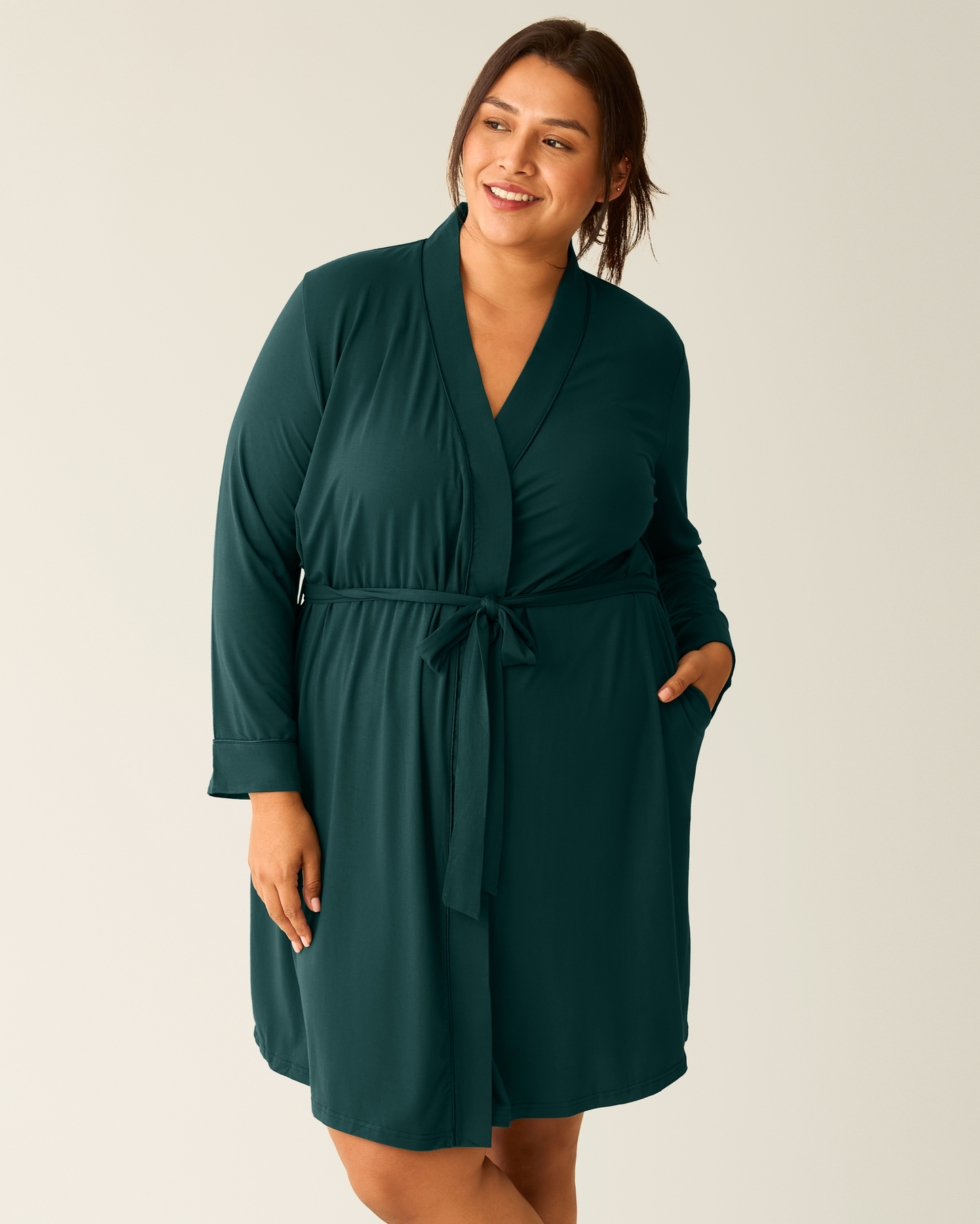 Woman wearing the Clea Bamboo Robe in Evergreen, with one hand in pocket@model_info:Victoria is 5'10" and wearing a L/XL.