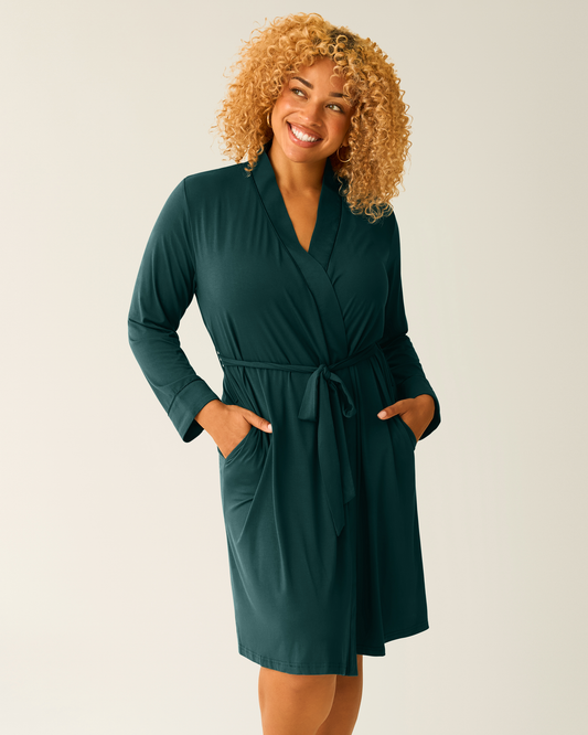 Woman wearing the Clea Bamboo Robe in Evergreen, with hands in pockets@model_info:Jade is 5'5" and wearing an S/M.