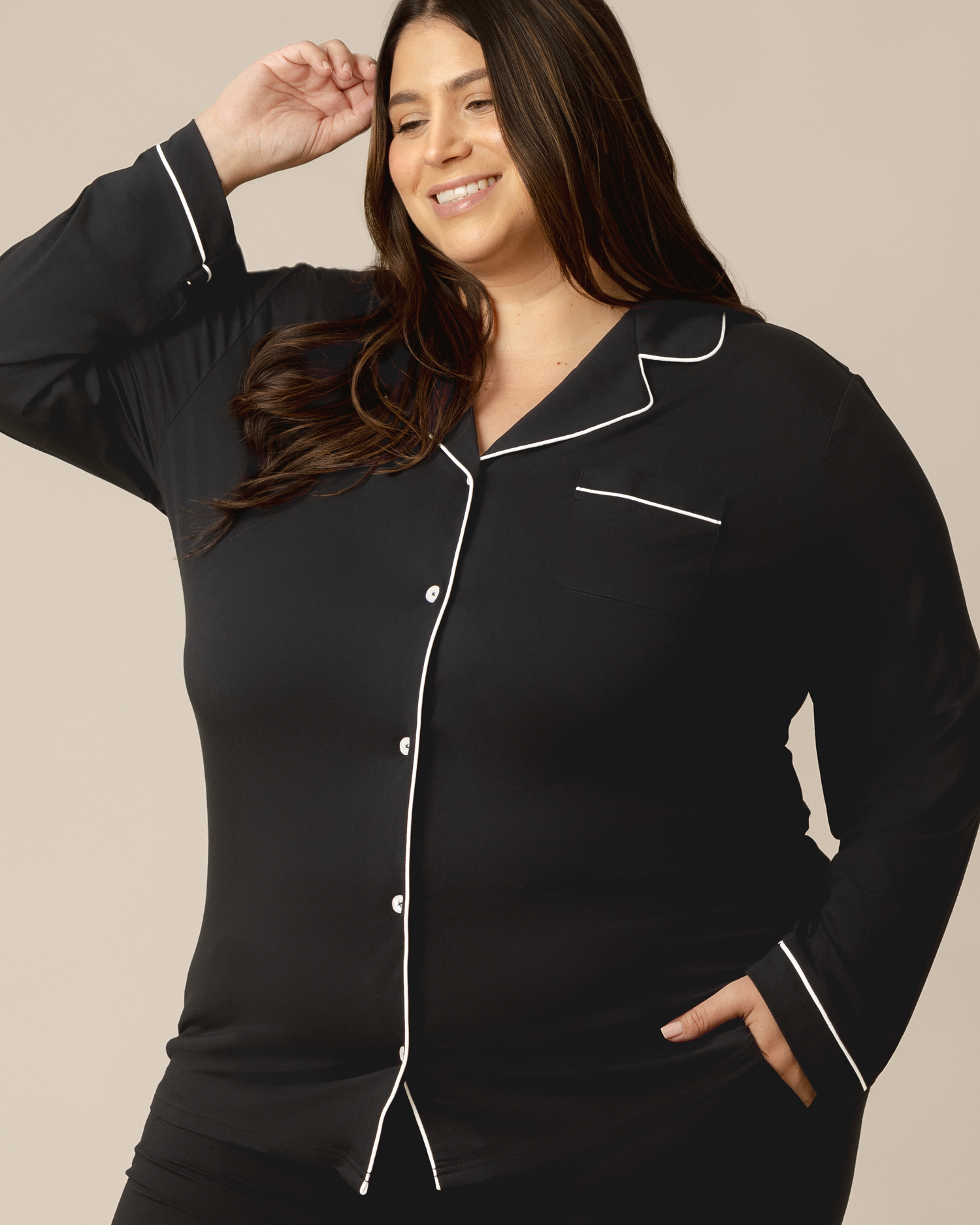 Front view of model wearing the Clea Bamboo Long Sleeve Pajama Set in Black showing top detail
