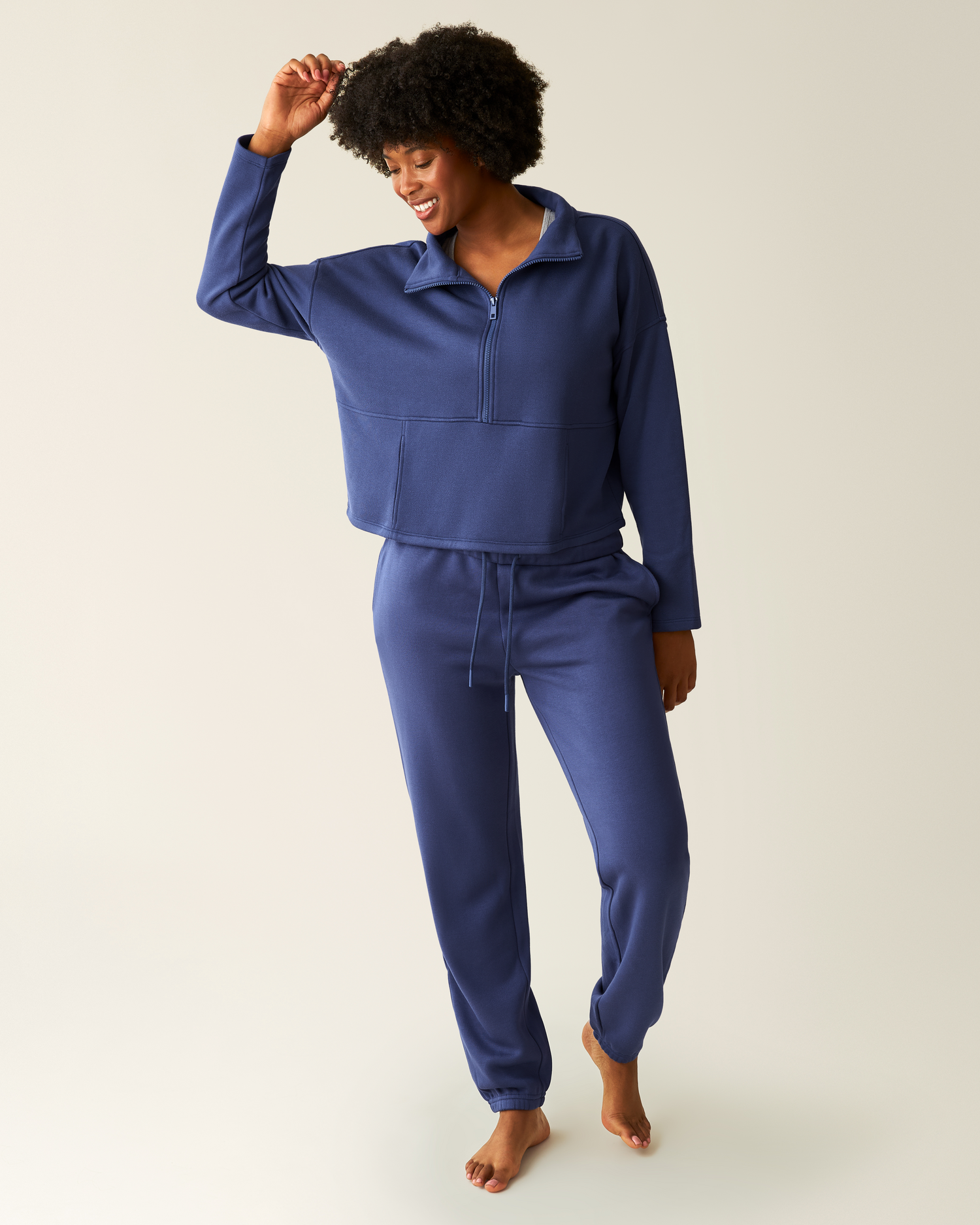 Woman wearing the Cloud Fleece Jogger in Deep Blue paired with matching Cloud Fleece Half-Zip Pullover