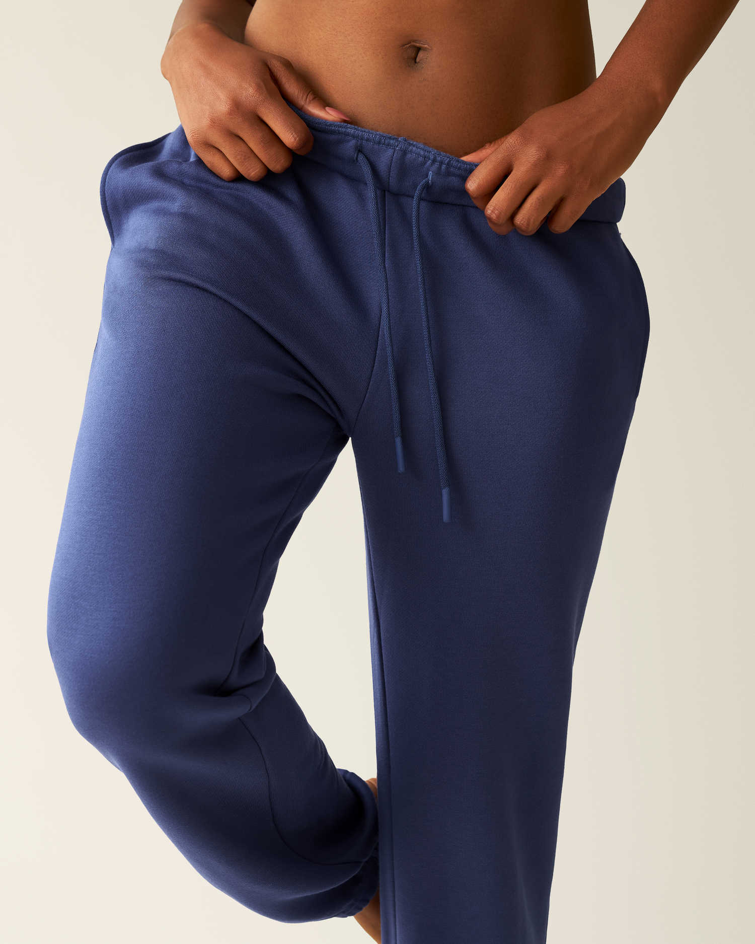 Cropped in image of woman wearing the Cloud Fleece Jogger in Deep Blue showing waistband and drawstring