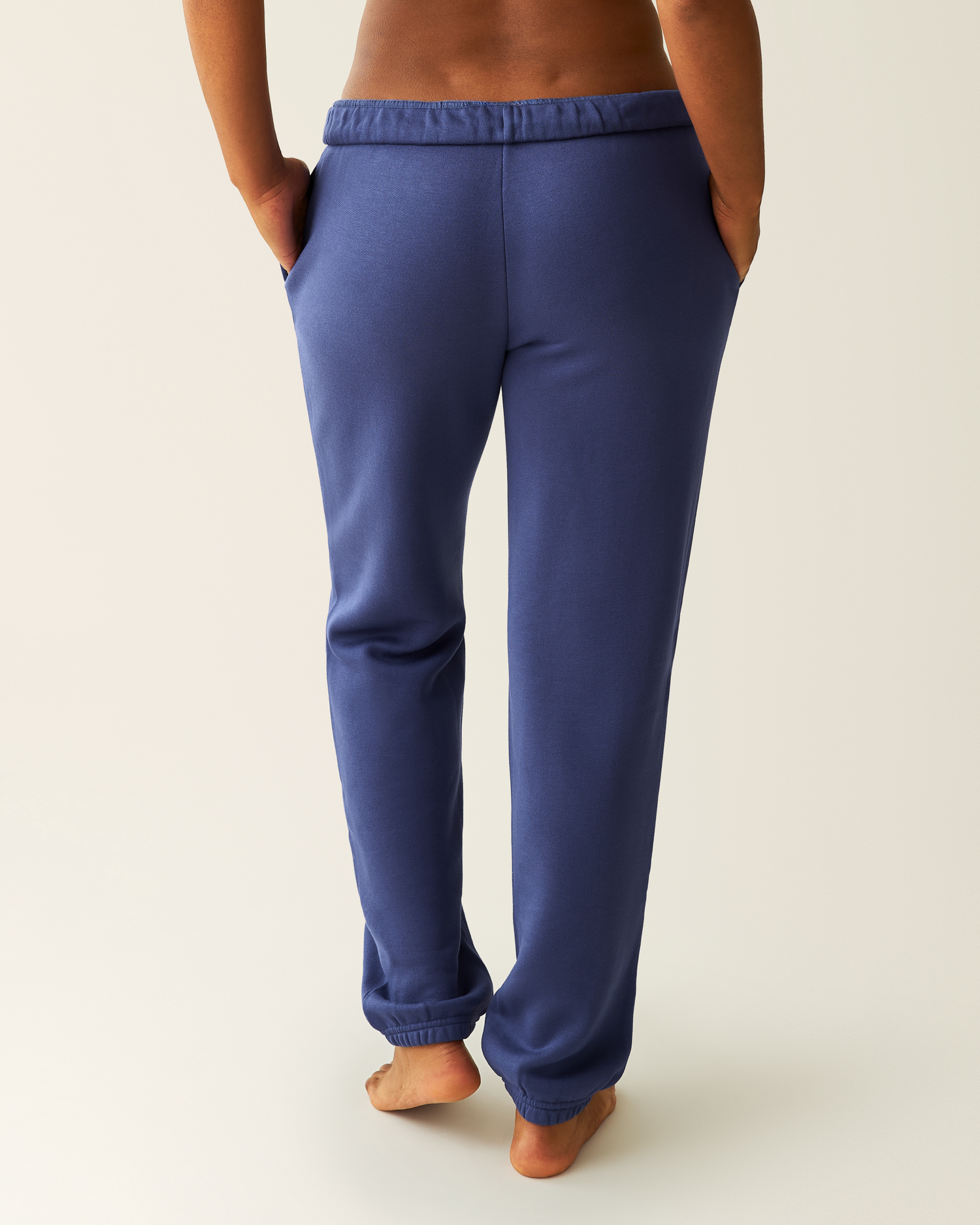 Close-up of woman wearing the Cloud Fleece Jogger in Deep Blue showing back of joggers