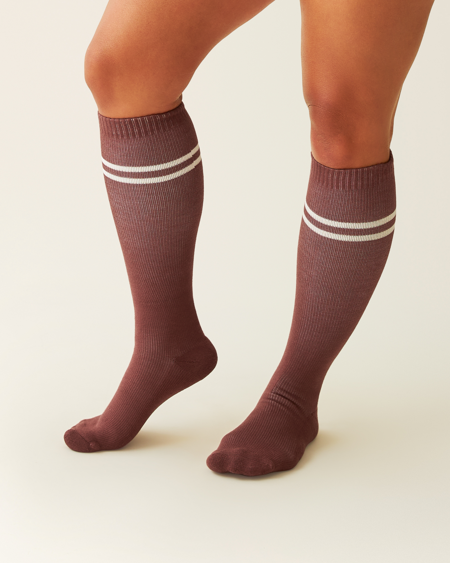 Redwood knee-high Premium Maternity Compression Socks with white stripes worn by a person on a beige background