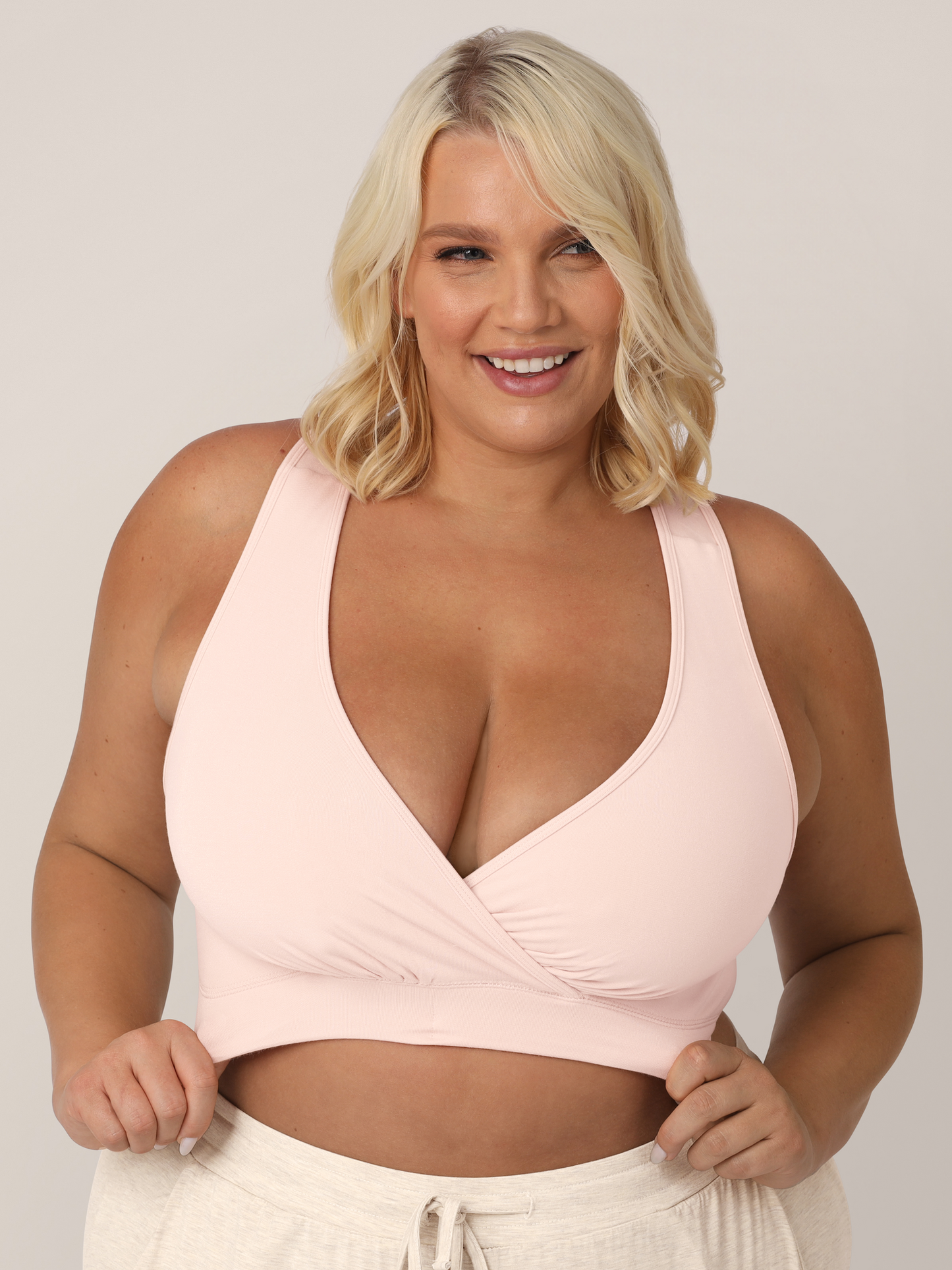 Zoomed in view of busty model wearing the French Terry Nursing Bra in Soft Pink.