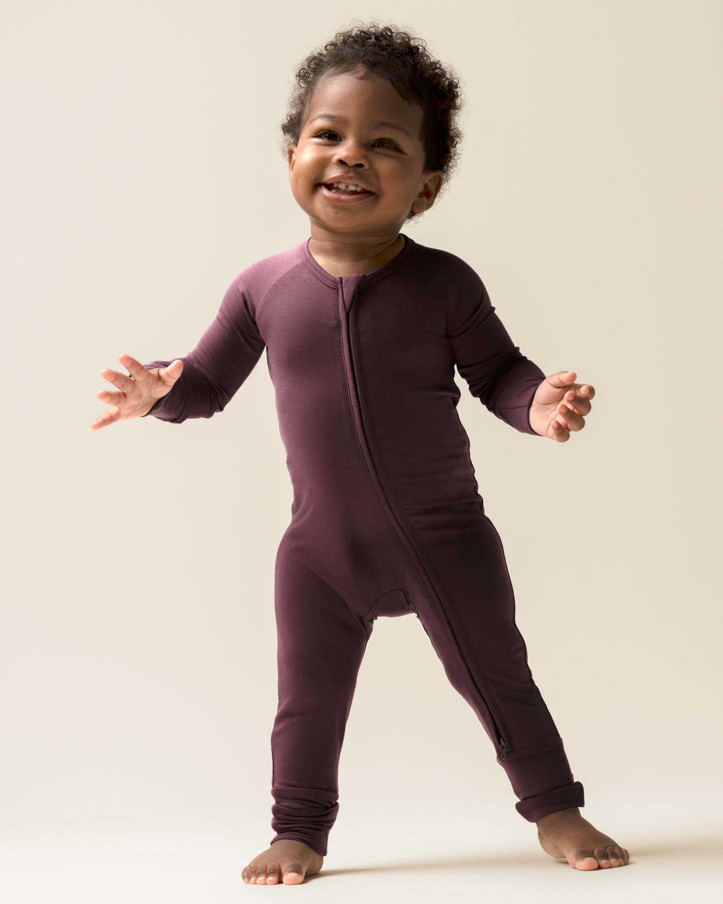 Child wearing Bamboo Baby Pajamas in Burgundy Plum against a plain background@model_info:Harper is wearing 3-6 months.