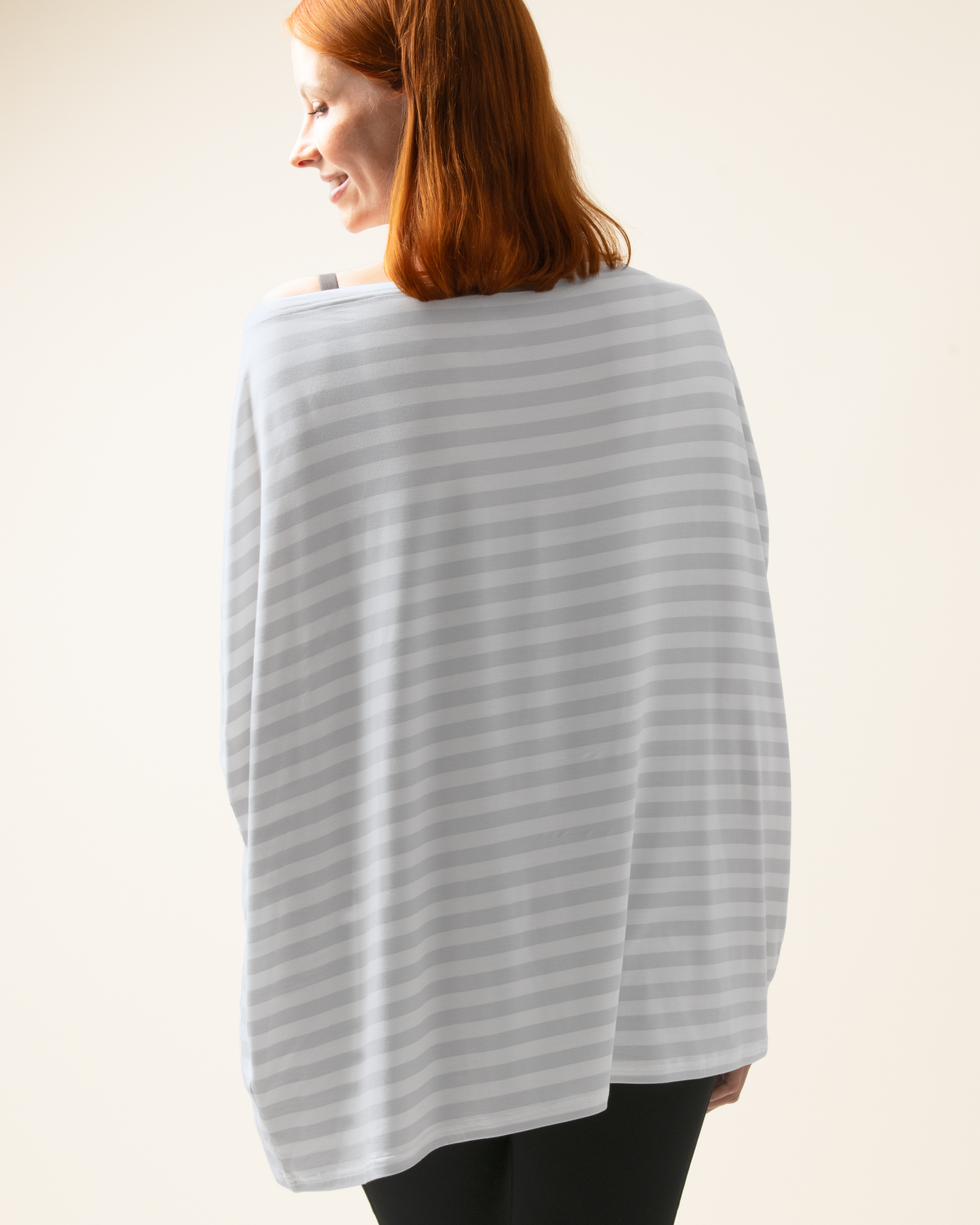 Woman wearing Bamboo Multi-Use Nursing Cover in Grey Stripe against a plain background