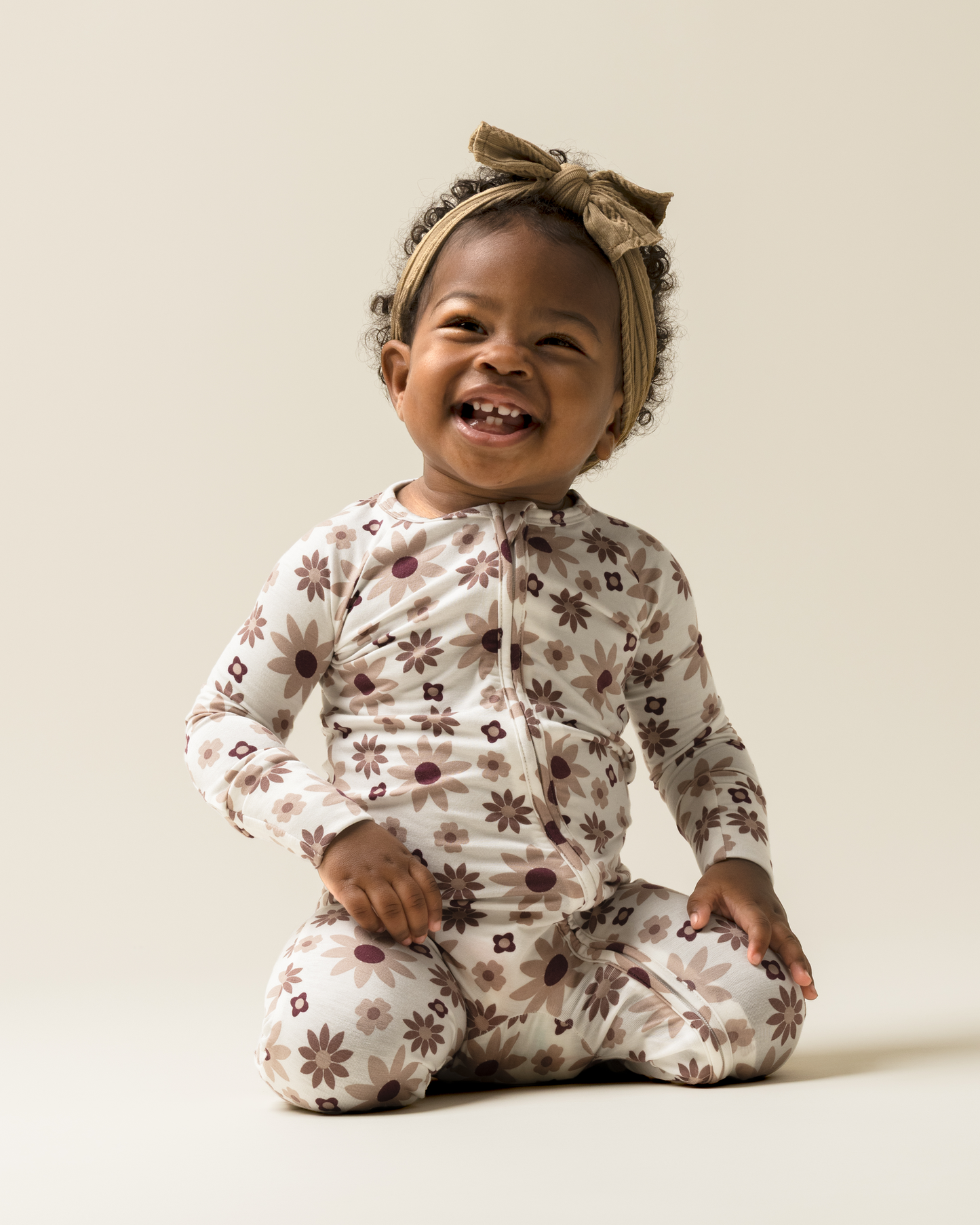 Baby sitting while wearing Baby Pajamas in Twilight Floral @model_info:Harper is wearing 3-6 months.