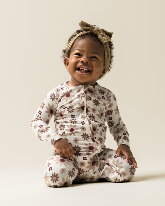 Baby sitting while wearing Baby Pajamas in Twilight Floral @model_info:Harper is wearing 3-6 months.