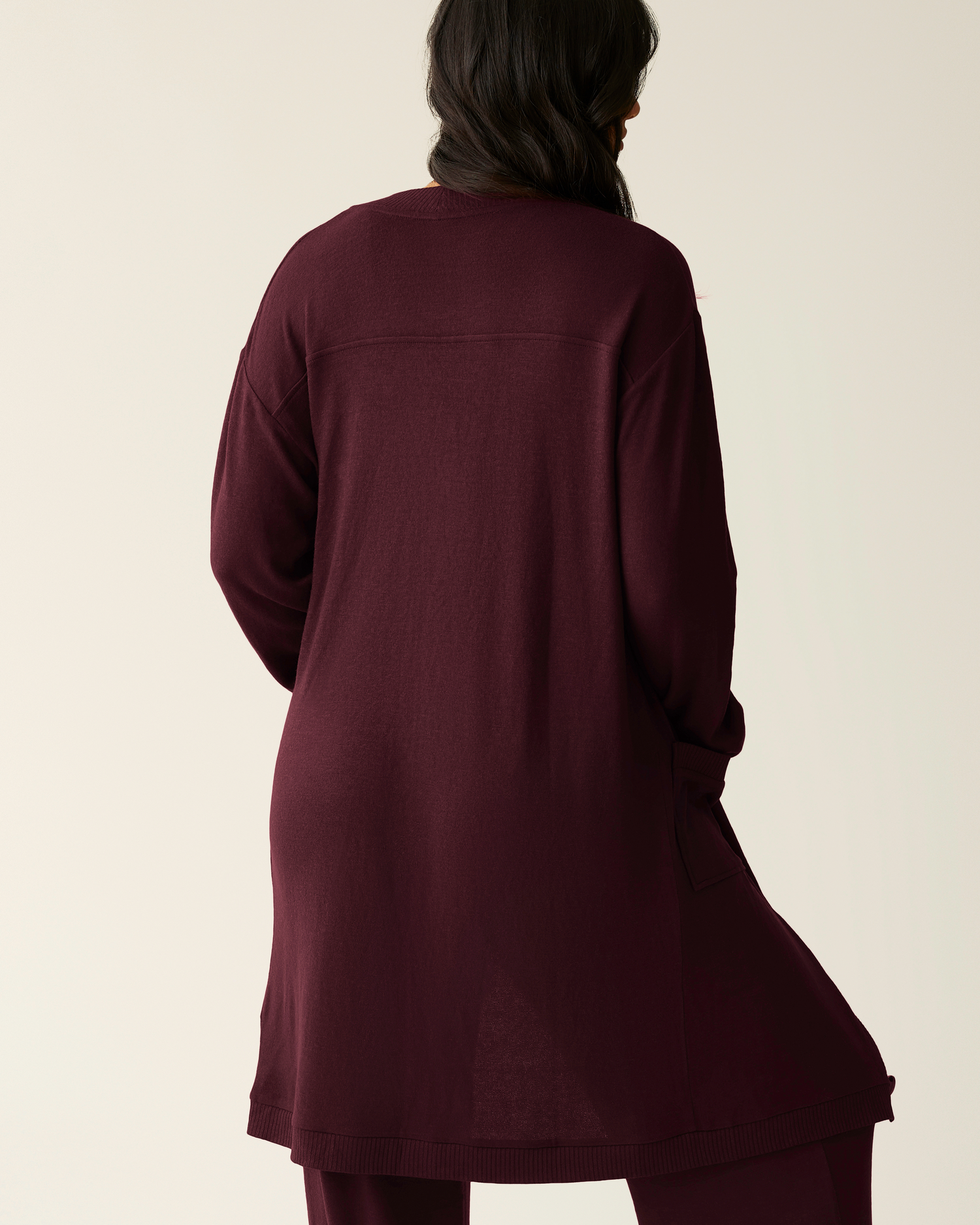 Back view of model wearing CozyKnit Long Cardigan in Deep Burgundy