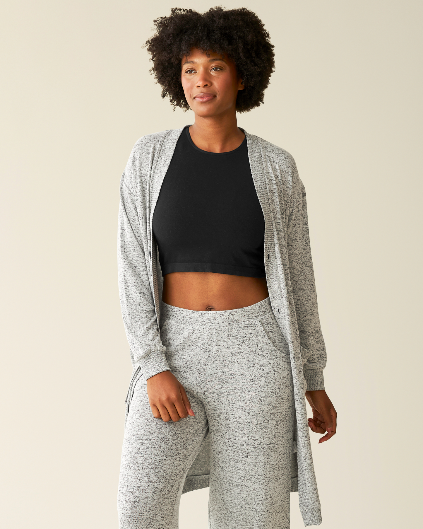 Front view of model wearing CozyKnit Long Cardigan in Grey Heather unbuttoned with a black top underneath