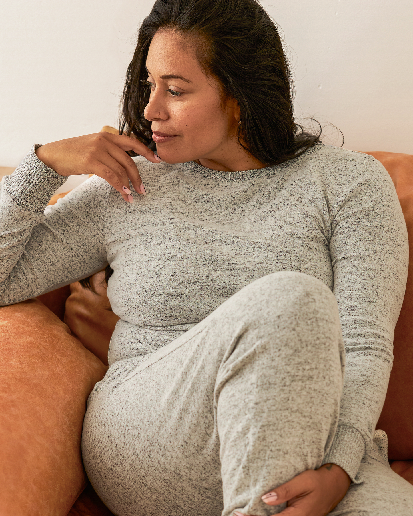 Model sitting on chair wearing CozyKnit Nursing Pajama & Lounge Set in Grey Heather@model_info:Lily is wearing a Large.
