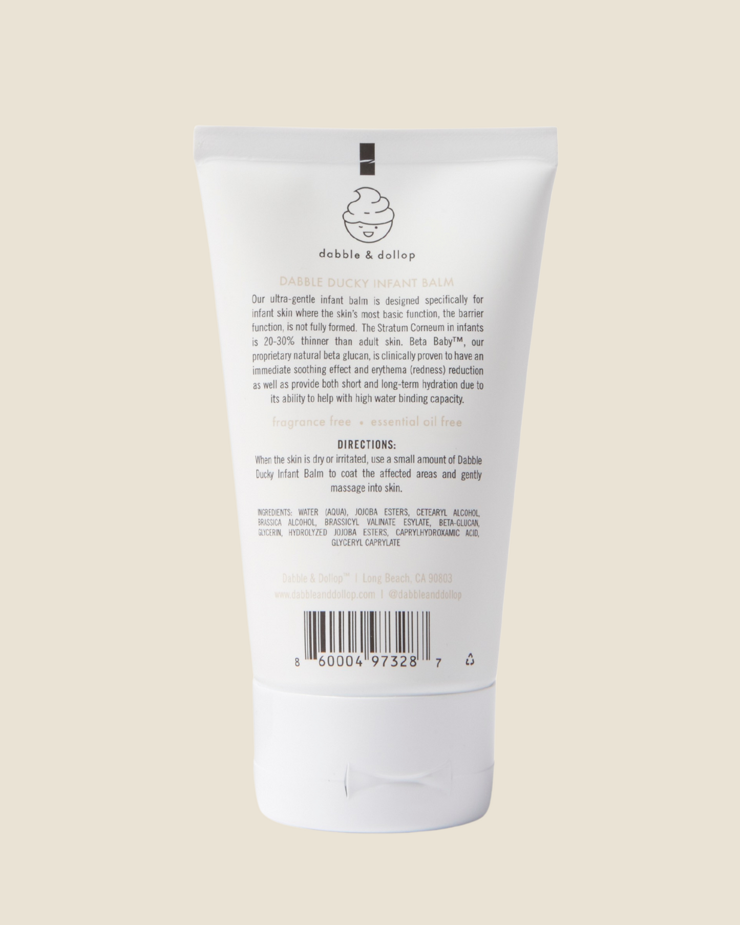 Back of Dabble & Dollop Dabble Ducky infant balm tube on a beige background