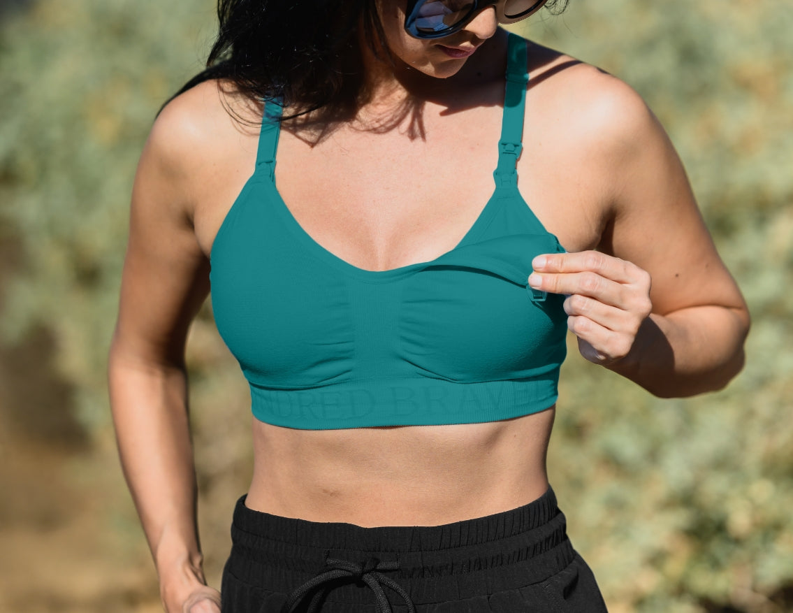 Model wearing the Sublime® Hands-Free Pumping & Nursing Sports Bra in Teal showing clip-down feature
