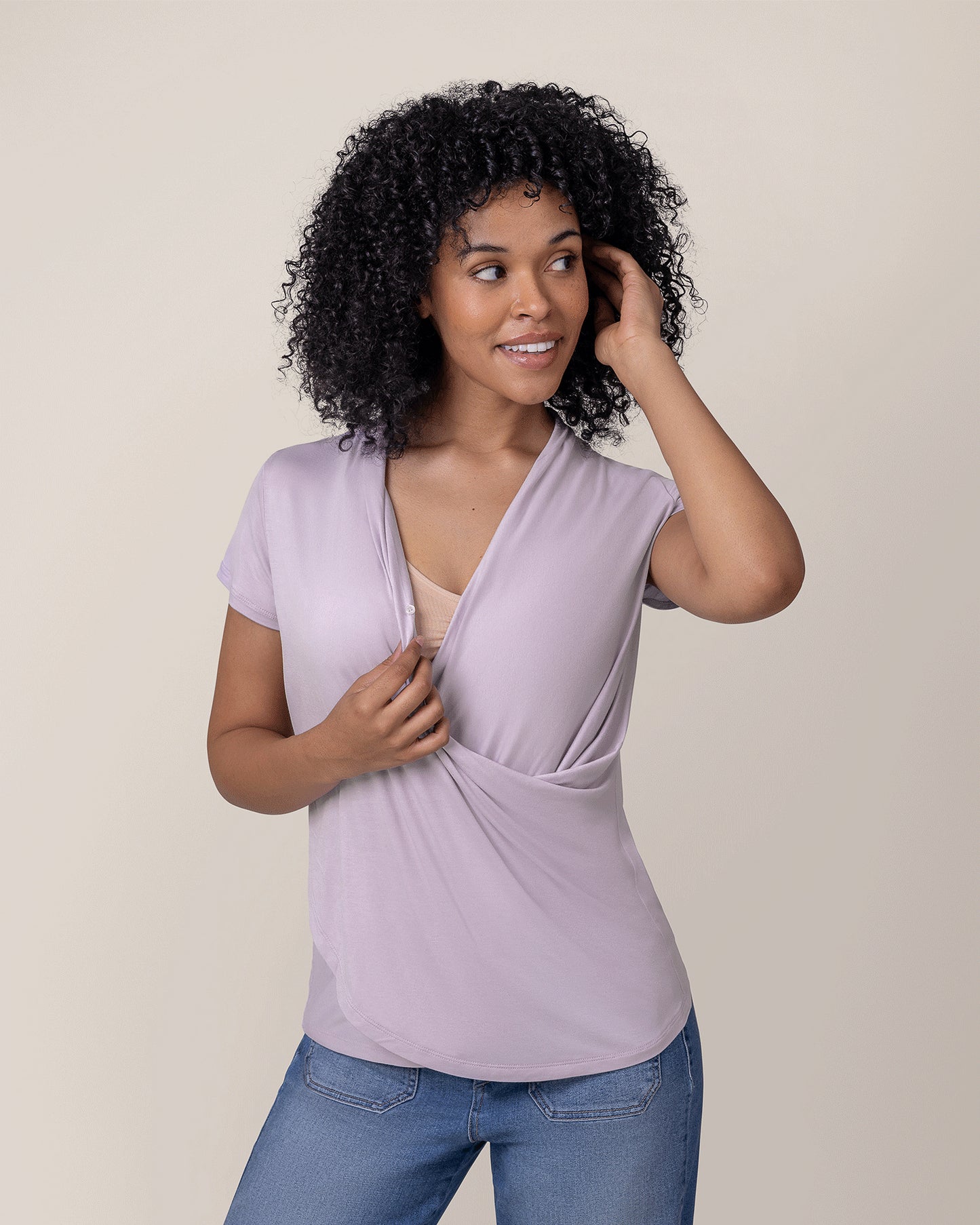 Model wearing the Bamboo Draped Nursing Top in Lavender Mist, pulling aside neckline to show nursing access