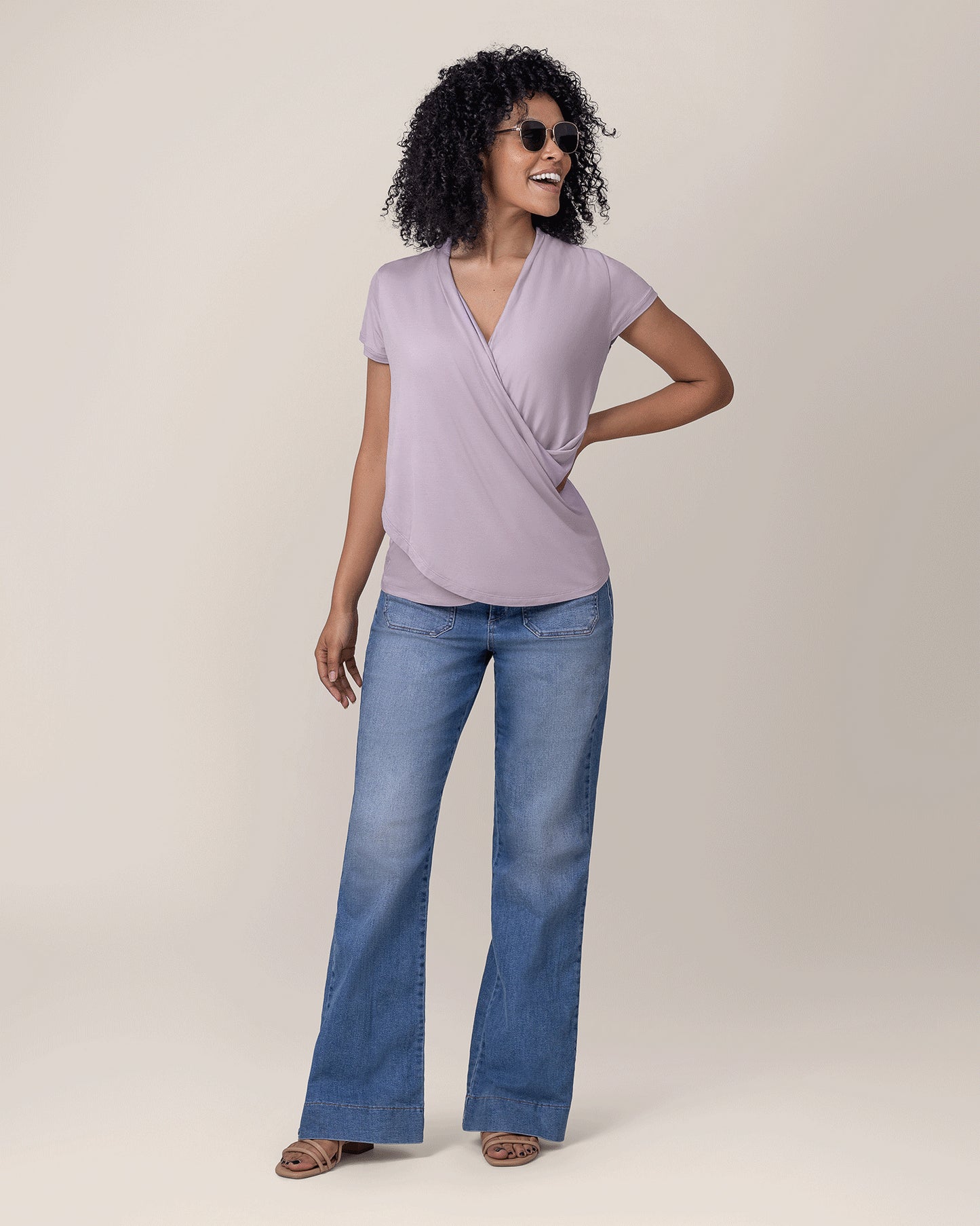 Model wearing the Bamboo Draped Nursing Top in Lavender Mist, paired with wide leg jeans and sandals