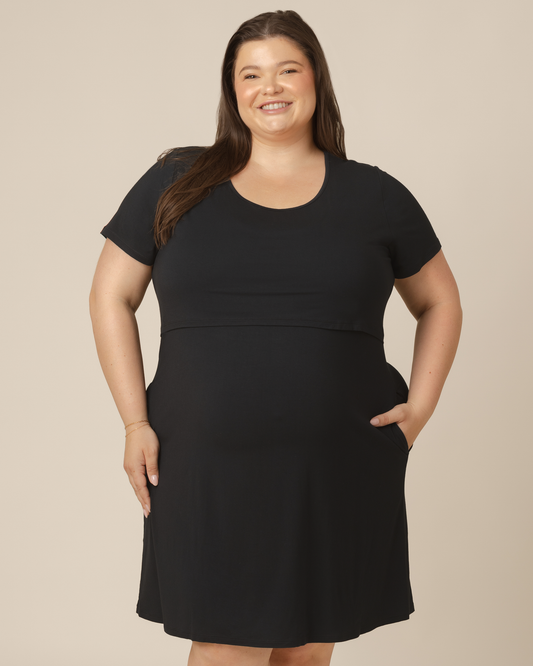 Front view of model wearing the Eleanora Bamboo Maternity & Nursing Dress in Black @model_info:Sam is wearing a 2X.