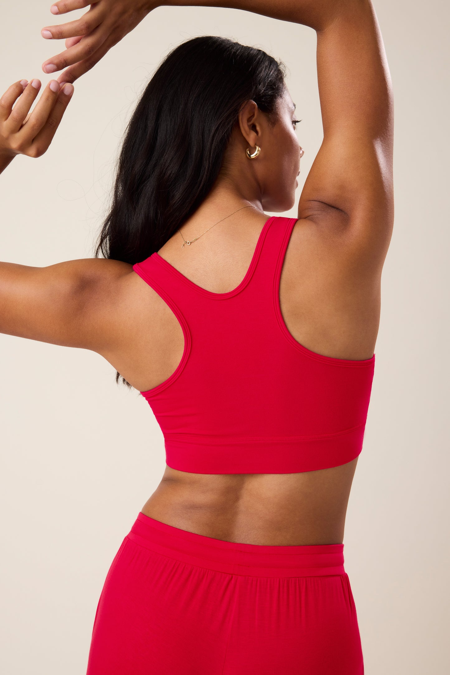 Model wearing French Terry Racerback Nursing & Sleep Bra in Red against a neutral background