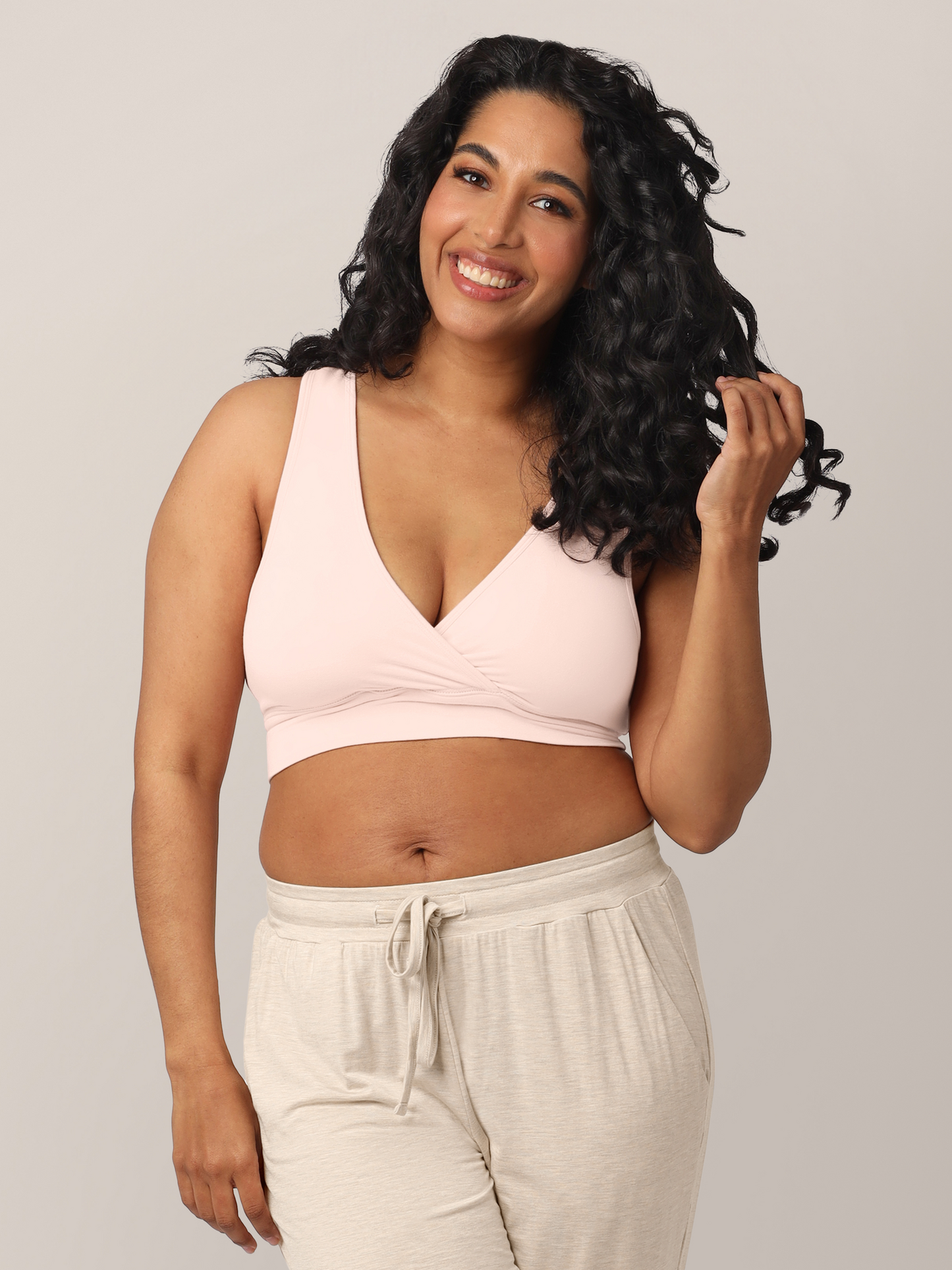Model wearing the French Terry Racerback Nursing & Sleep Bra in Soft Pink @model_info:Zakeeya is wearing a Small.
