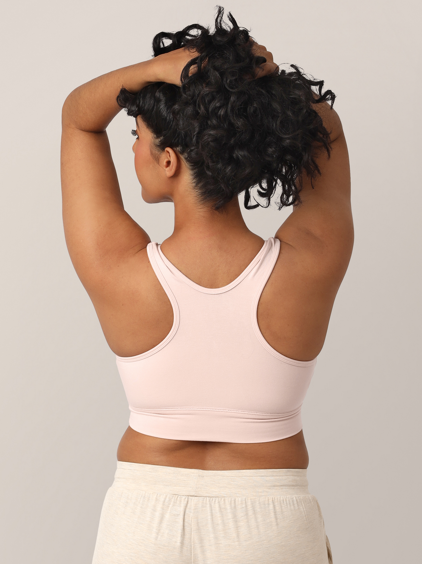 Back view of a model wearing the French Terry Racerback Nursing & Sleep Bra in Soft Pink