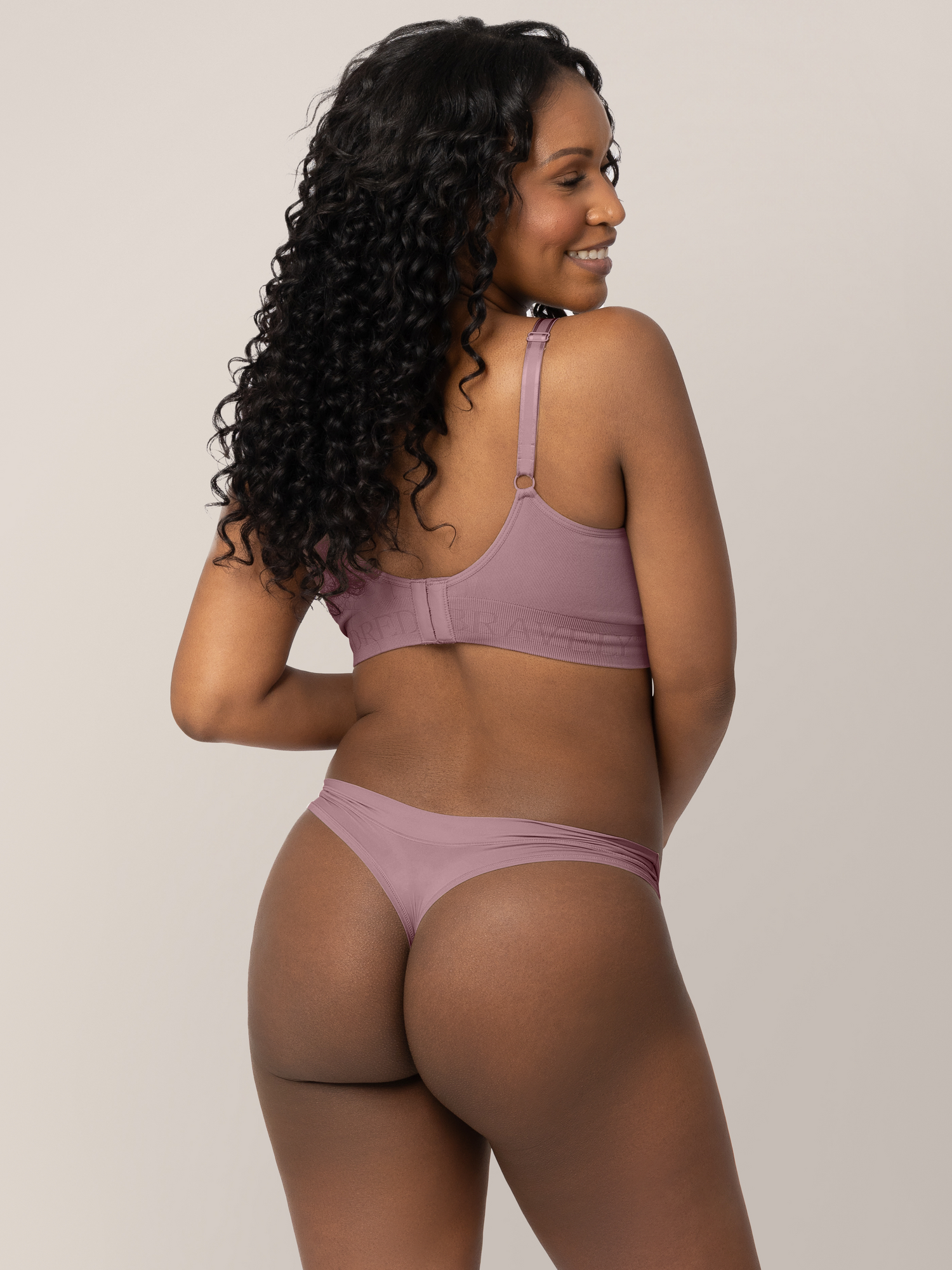Back of a model wearing the Grow with Me™ Maternity & Postpartum Thong in Twilight.