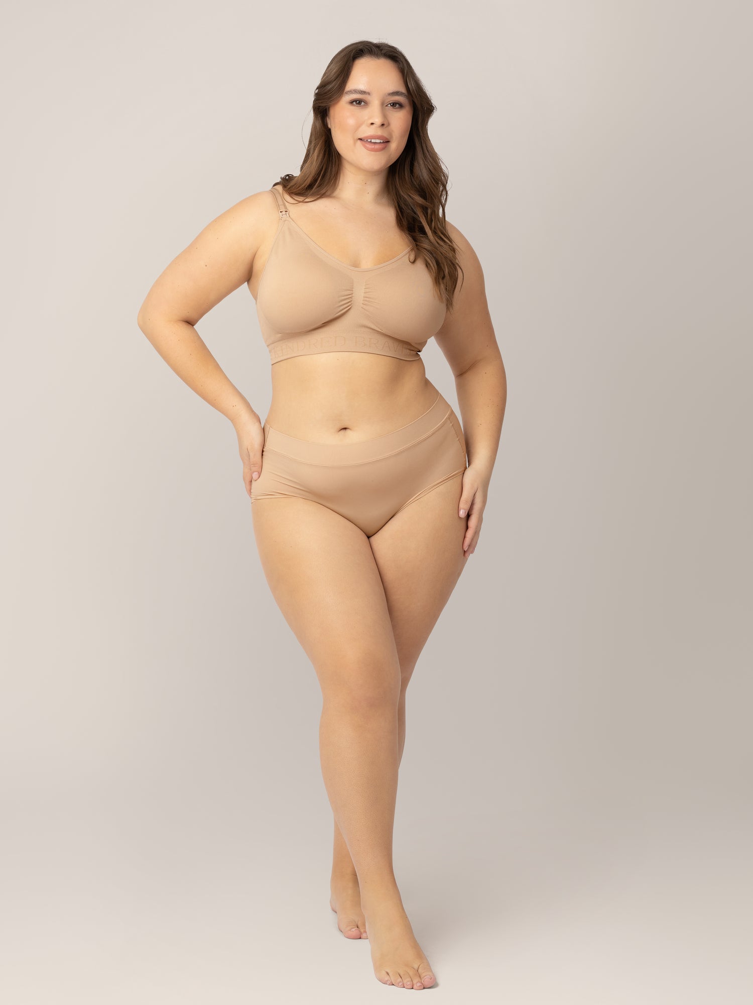 Model wearing the Grow with Me™ Maternity & Postpartum Brief in Beige with her hand on her hip.