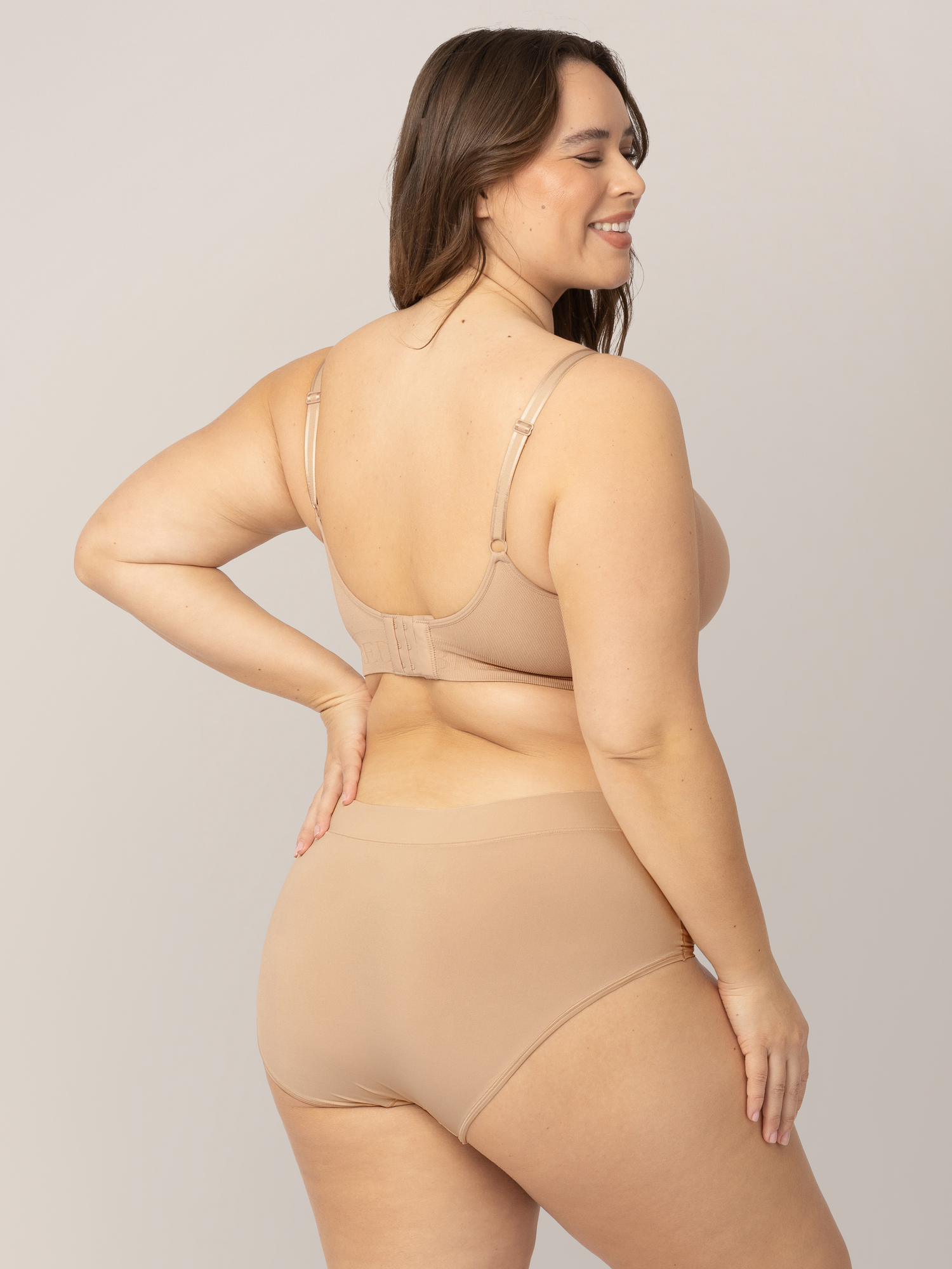 Back of a model wearing the Grow with Me™ Maternity & Postpartum Brief in Beige