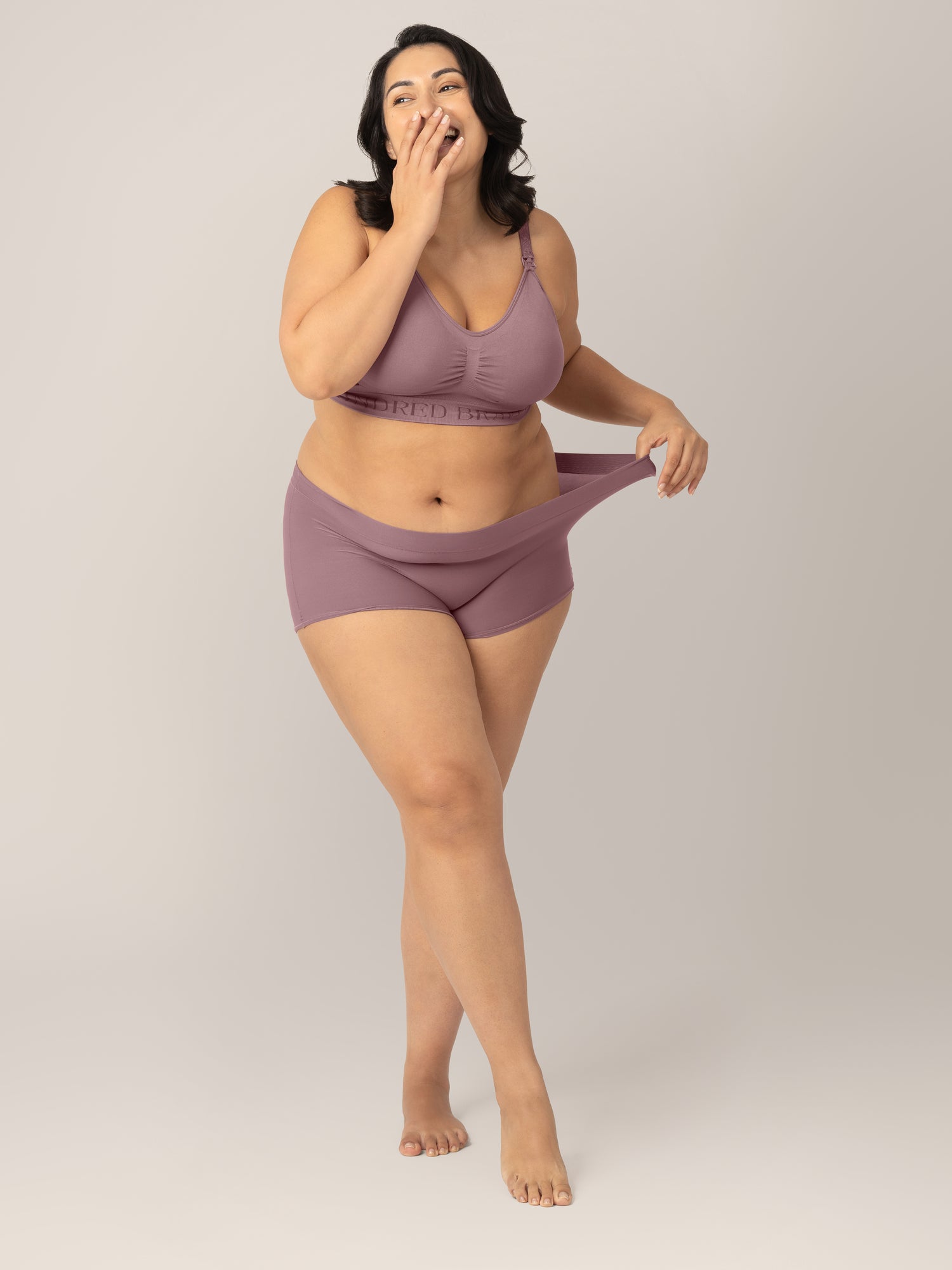 Model wearing the Twilight Grow with Me™ Maternity & Postpartum Boyshort and pulling the waistband to show stretch.