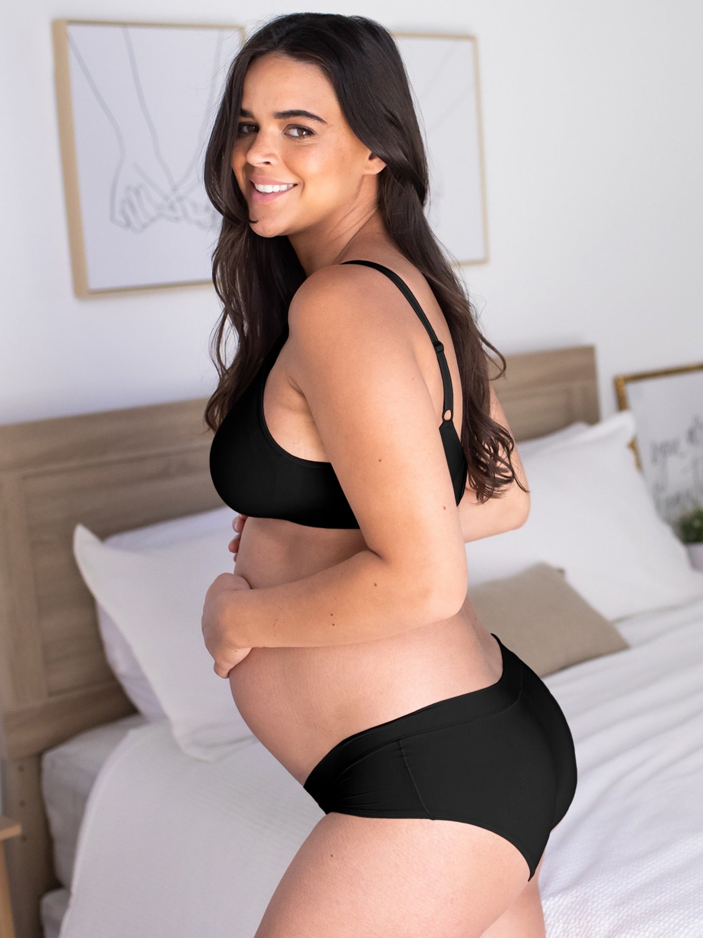 Pregnant model wearing the Grow with Me™ Maternity & Postpartum Hipster in black
