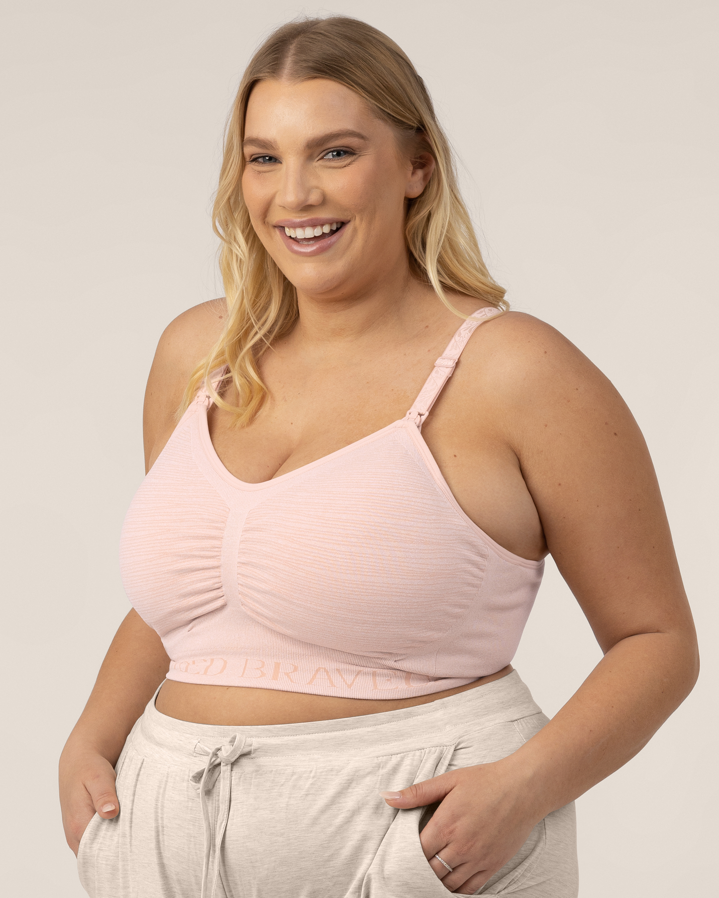 Busty model wearing the SublimeĀ® Hands-Free Pumping & Nursing Bra in Pink Heather @model_info:Lauren is wearing an X-Large Busty.
