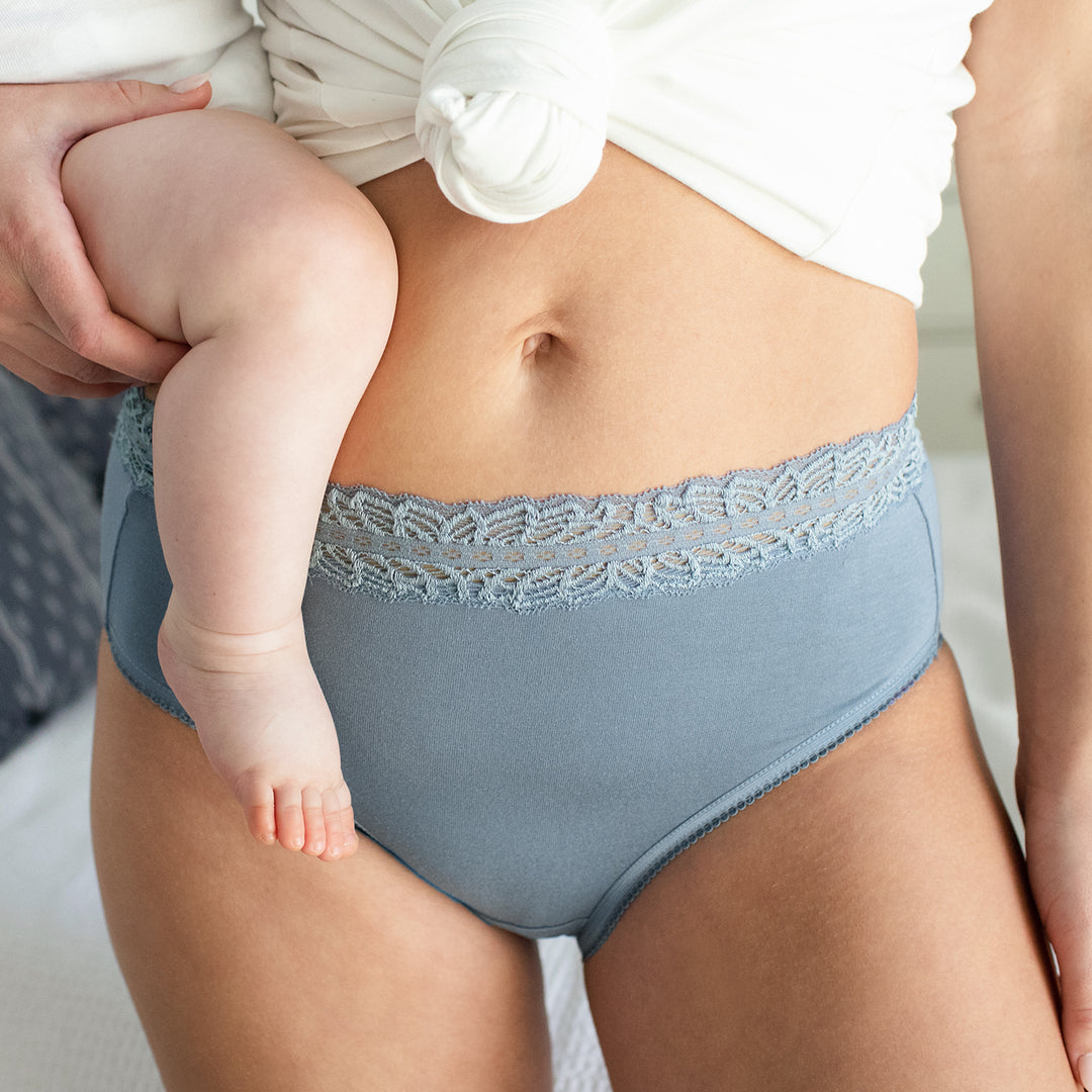 Close-up of the High-Waisted Postpartum Underwear on model, holding babt