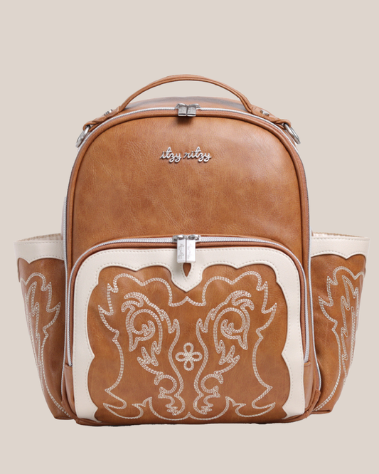 Front view of the Itzy Ritzy - Nash Itzy Mini Plus™ Diaper Bag in Saddle