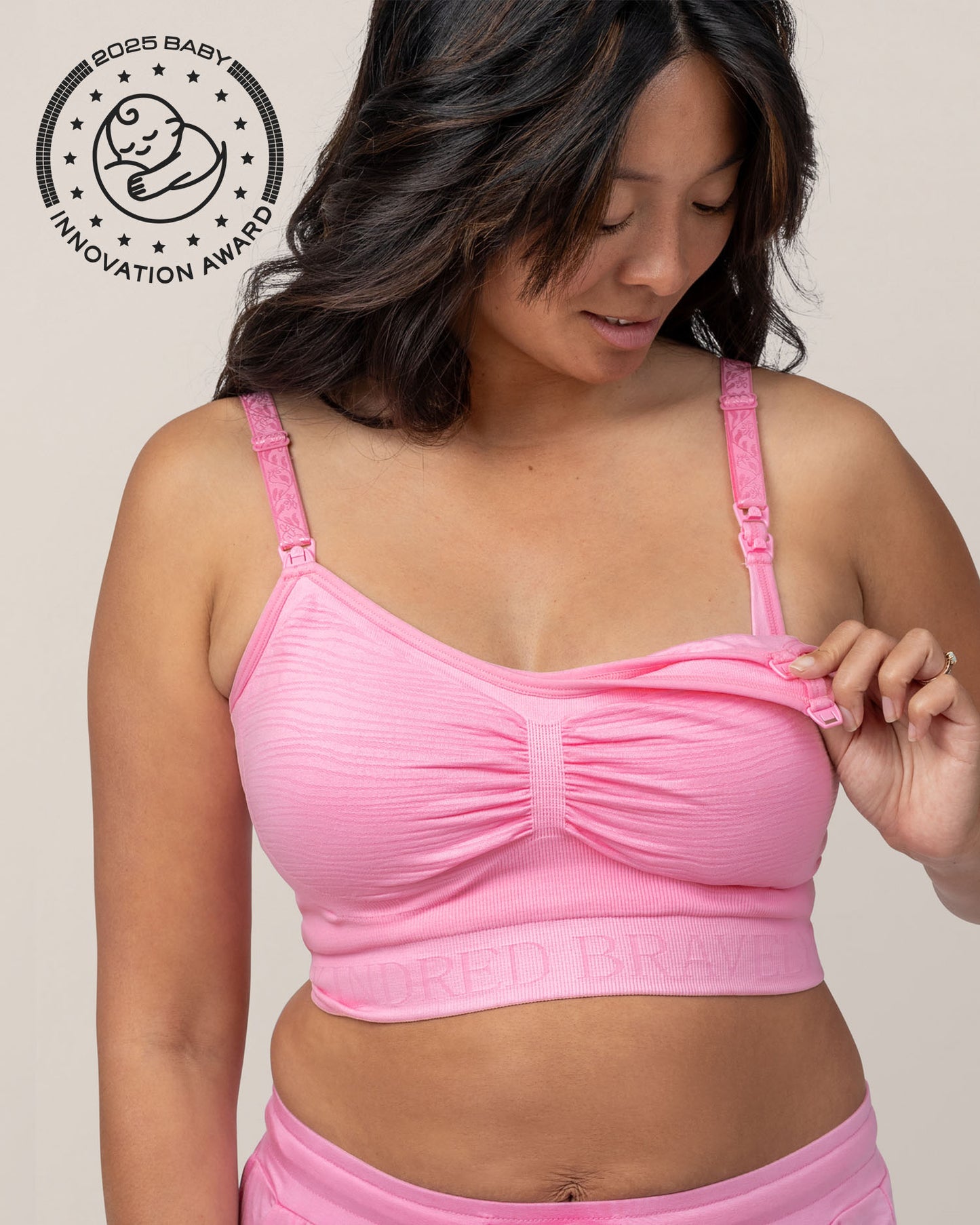 Model showing clip down nursing and pumping access while wearing Sublime® Hands-Free Pumping & Nursing Bra in Bubblegum with matching Everyday Lounge Joggers @model_info:Hillary is wearing a Small.