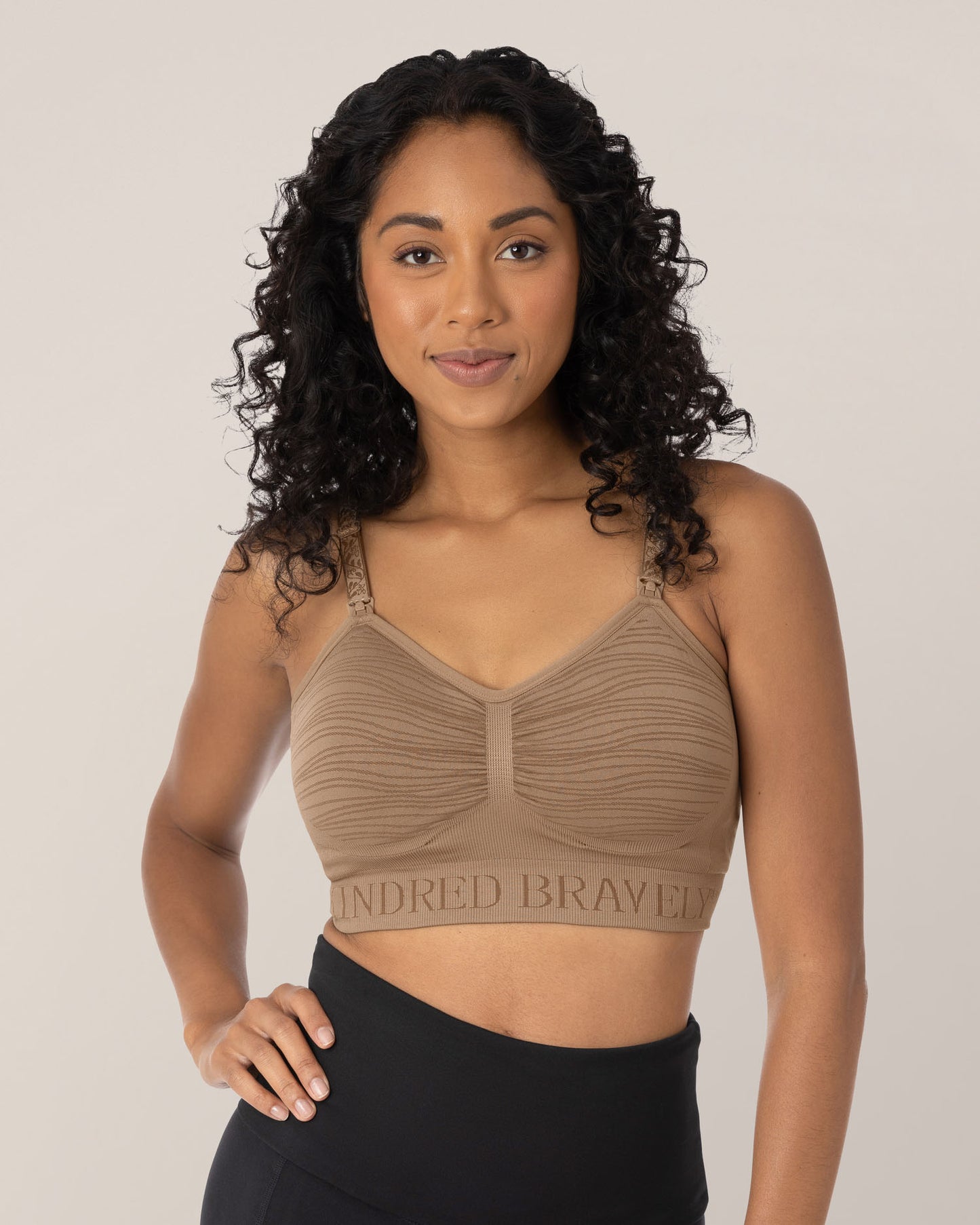 Model in the Sublime® Hands-Free Pumping & Nursing Bra in Latte, with one hand on her hip. @model_info:Anastacia is wearing a Small.